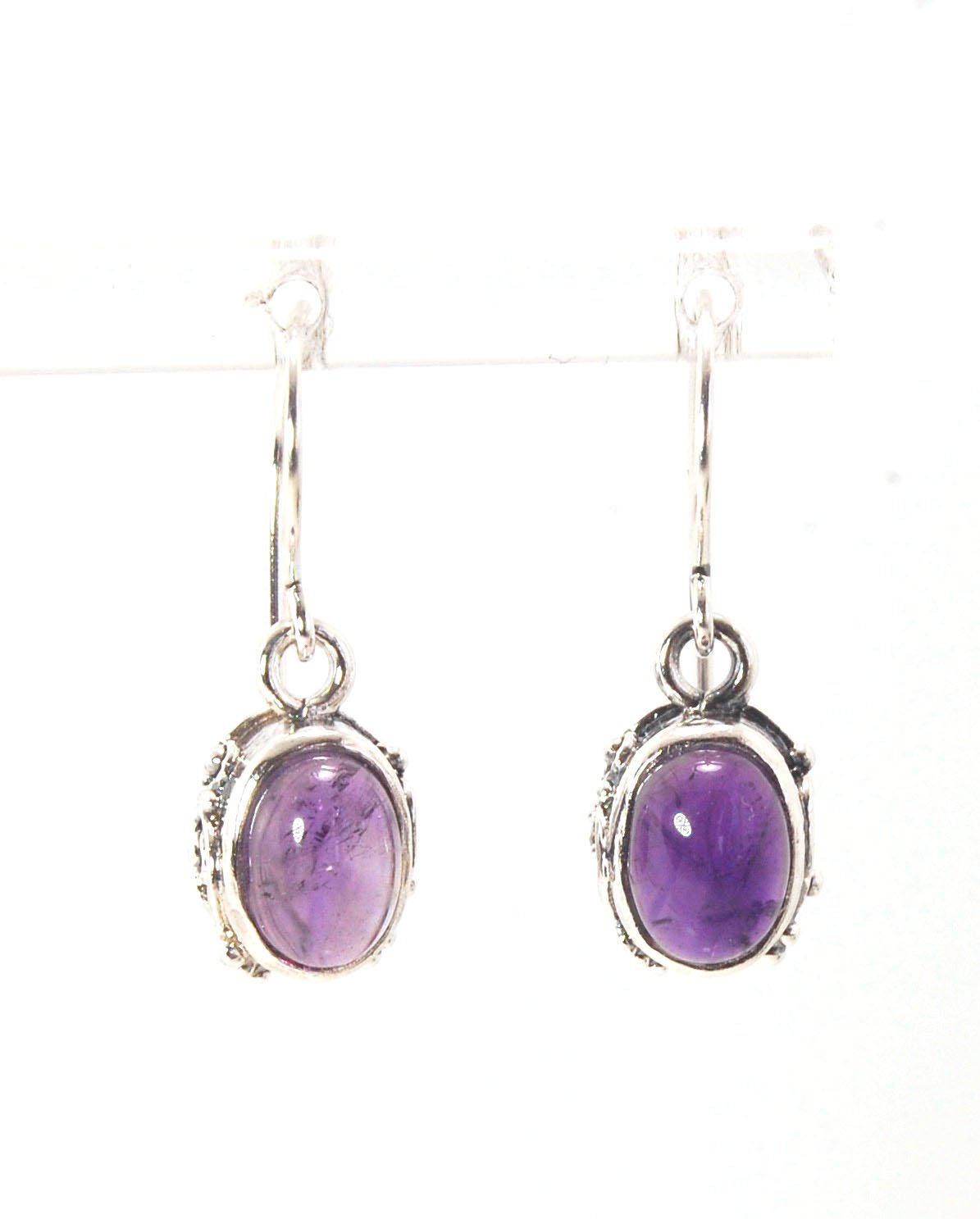 Oval Amethyst Earrings in Swirled silver bezel setting with french hook These are cast in my studio using the ancient technique of lost wax casting, and are molded in wax from an original granulated piece in fine silver. These sweet ovals are reminiscent