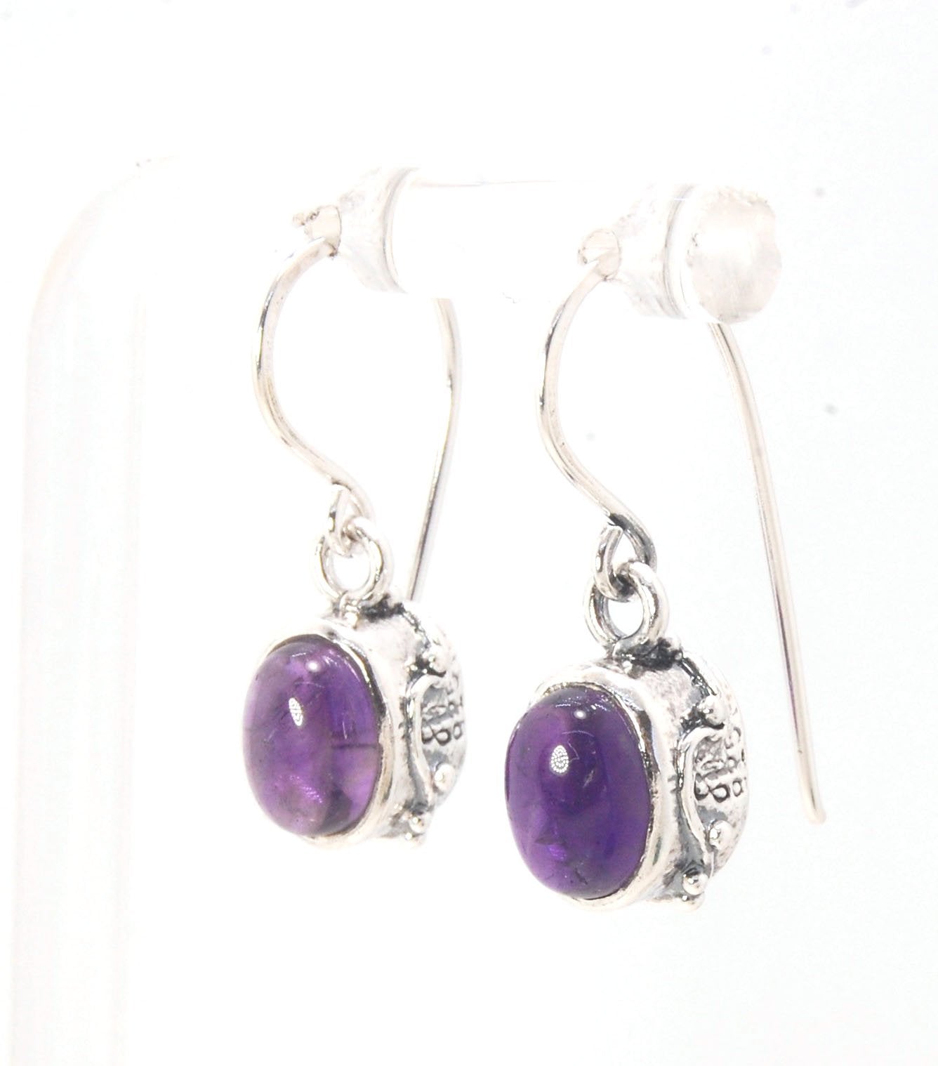 Oval Amethyst Earrings in Swirled silver bezel setting with french hook These are cast in my studio using the ancient technique of lost wax casting, and are molded in wax from an original granulated piece in fine silver. These sweet ovals are reminiscent