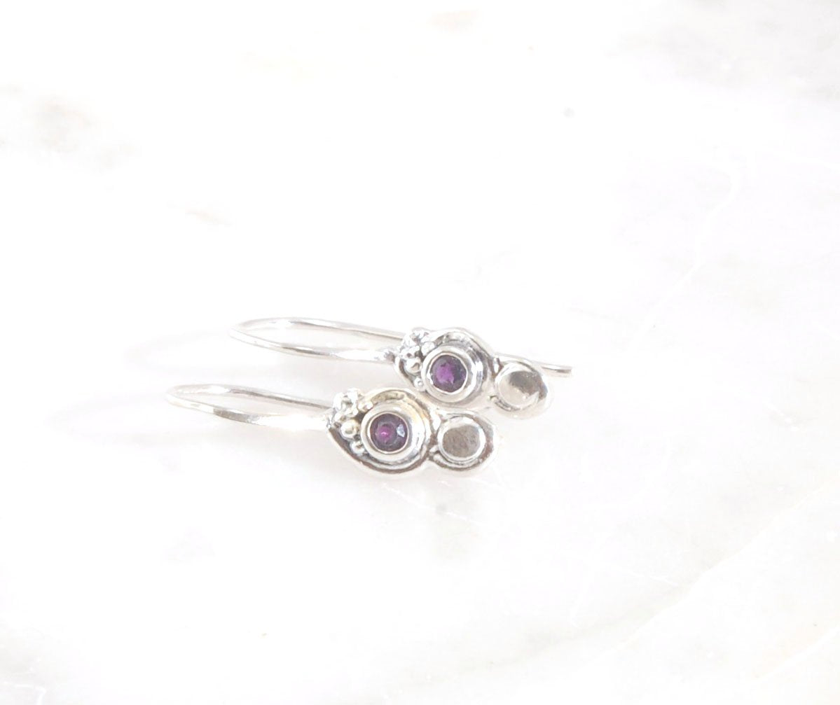 Wisteria Dangle Earrings in Amethyst, Garnet, or Topaz These delicate Wisteria earrings are cast in sterling silver from a Fine Silver granulated original. The have a fixed sterling french hook and can be set with amethyst faceted gem, garnet faceted gems