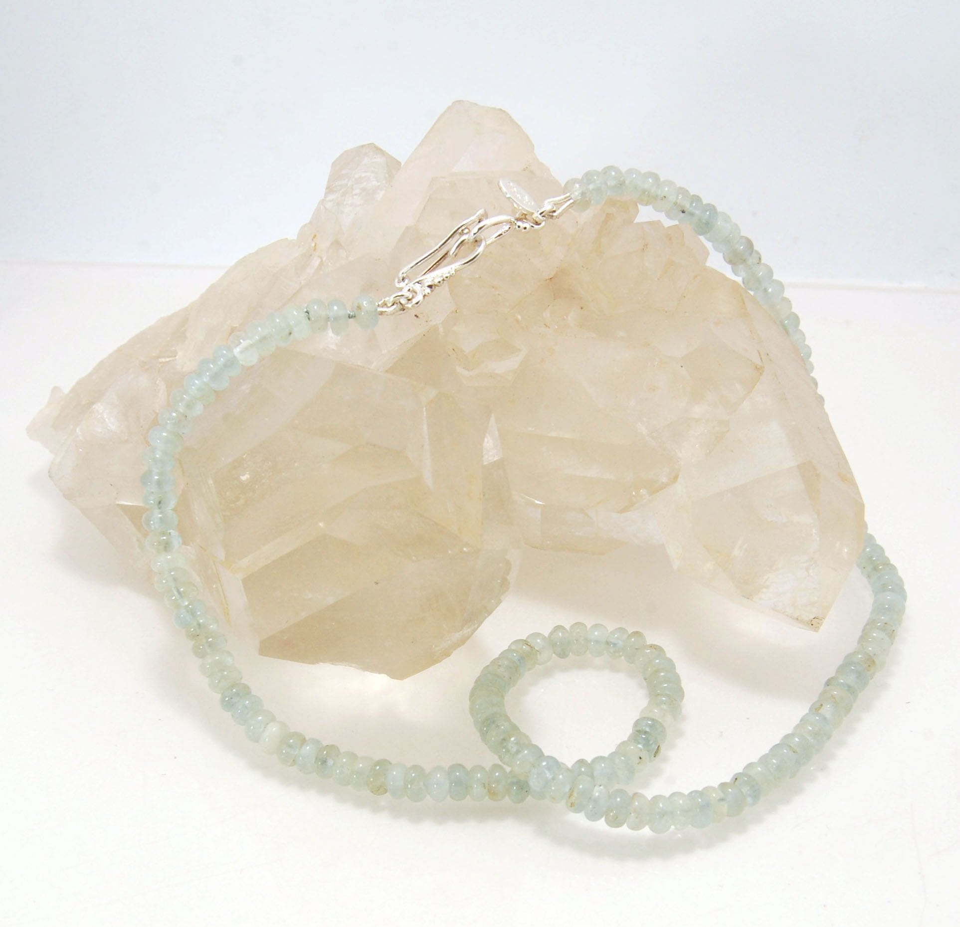 Aquamarine Gemstone Bead Strand with Granulated Sterling Silver safety clasp These ocean-colored Aquamarine rondelle gemstone beads are just lovely on! These beauties have a nice weight and warmth. I have made a sterling silver two-part safety clasp with