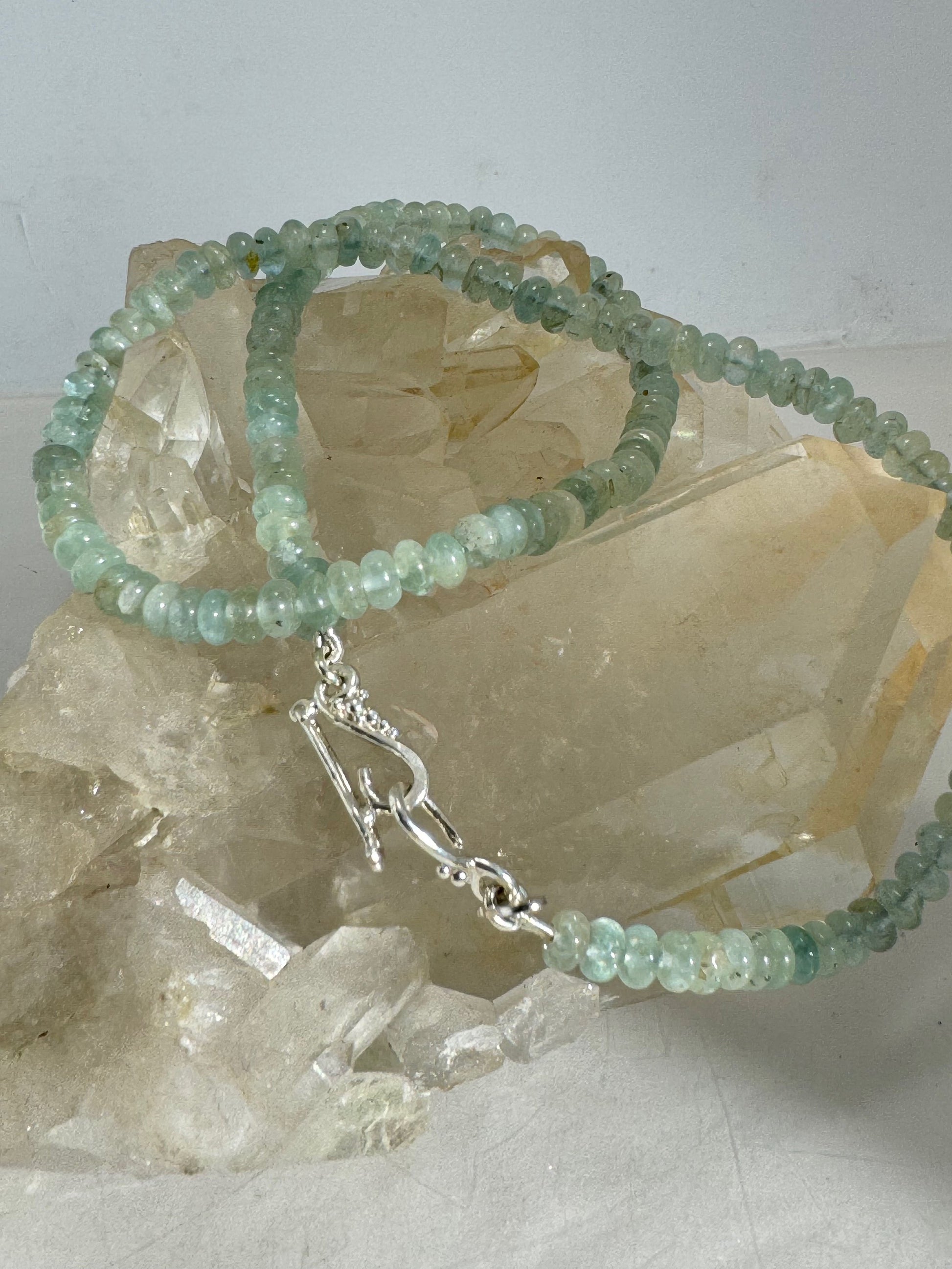 Aquamarine Gemstone Bead Strand with Granulated Sterling Silver safety clasp These ocean-colored Aquamarine rondelle gemstone beads are just lovely on! These beauties have a nice weight and warmth. I have made a sterling silver two-part safety clasp with