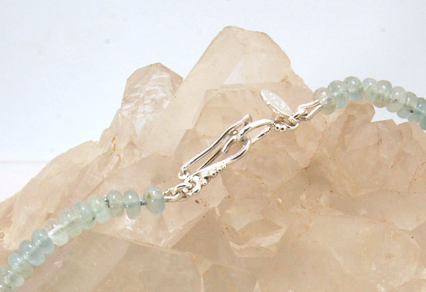 Aquamarine Gemstone Bead Strand with Granulated Sterling Silver safety clasp These ocean-colored Aquamarine rondelle gemstone beads are just lovely on! These beauties have a nice weight and warmth. I have made a sterling silver two-part safety clasp with