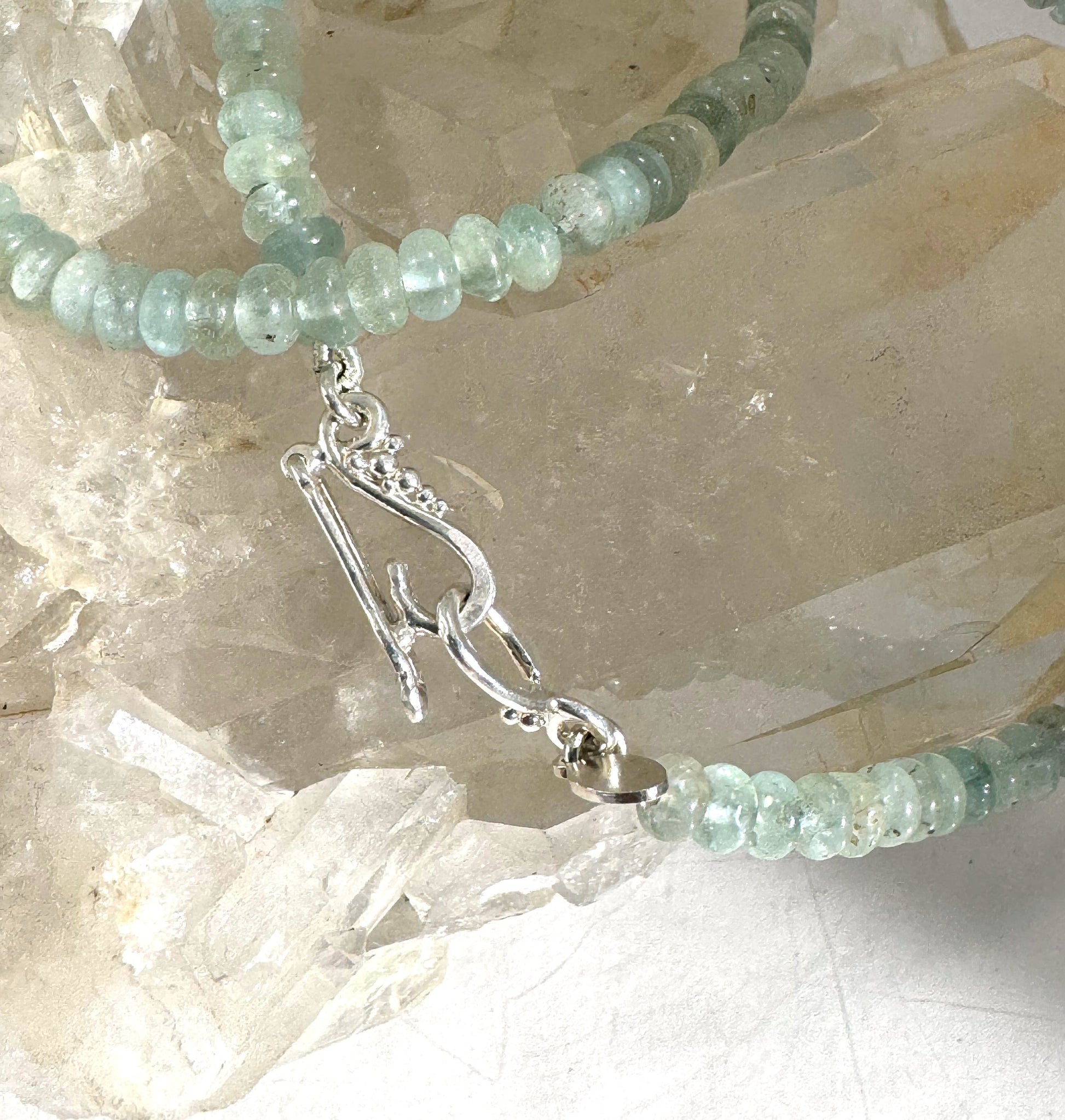 Aquamarine Gemstone Bead Strand with Granulated Sterling Silver safety clasp These ocean-colored Aquamarine rondelle gemstone beads are just lovely on! These beauties have a nice weight and warmth. I have made a sterling silver two-part safety clasp with