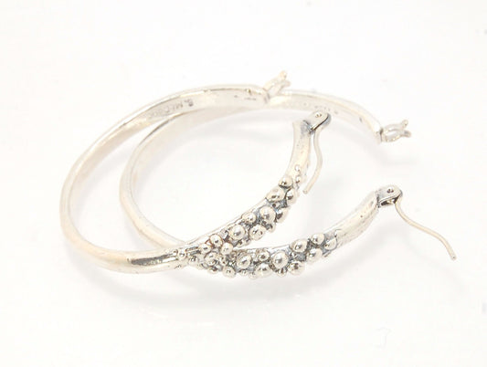 Bubble Hoops in Sterling These are great, unusual sterling silver bubble hoops. Carved in Wax and Cast in sterling silver with a lost wax process in my studio, these bubble beauties have a nice weight and the ear wire and clasp have a satisfying click. Da