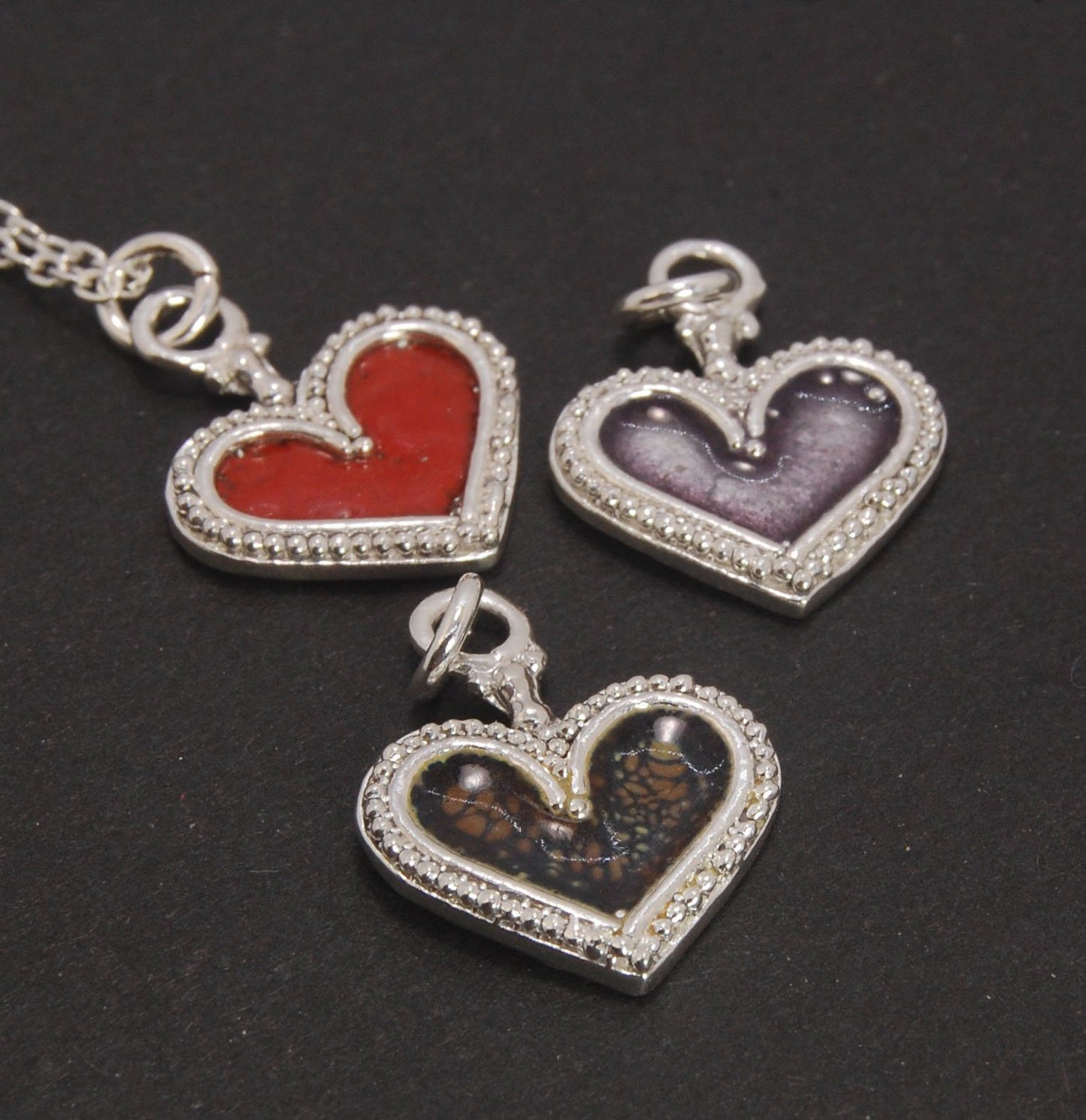 Enamel Heart Charm in Fine SIlver It’s a HEART of fine silver granulation that I made a mold of, then cast, then enameled! In your choice of colors: Red, Purple, Green, Black, Azalea, HollyhockGranulation is an ancient fusing process utilized for thousand