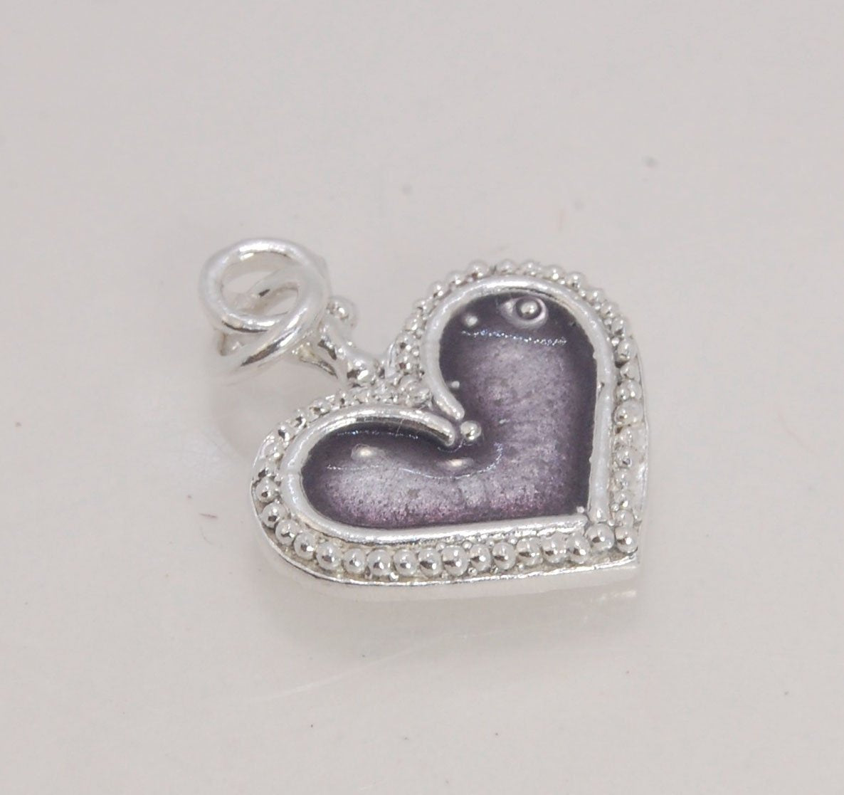 Enamel Heart Charm in Fine SIlver It’s a HEART of fine silver granulation that I made a mold of, then cast, then enameled! In your choice of colors: Red, Purple, Green, Black, Azalea, HollyhockGranulation is an ancient fusing process utilized for thousand