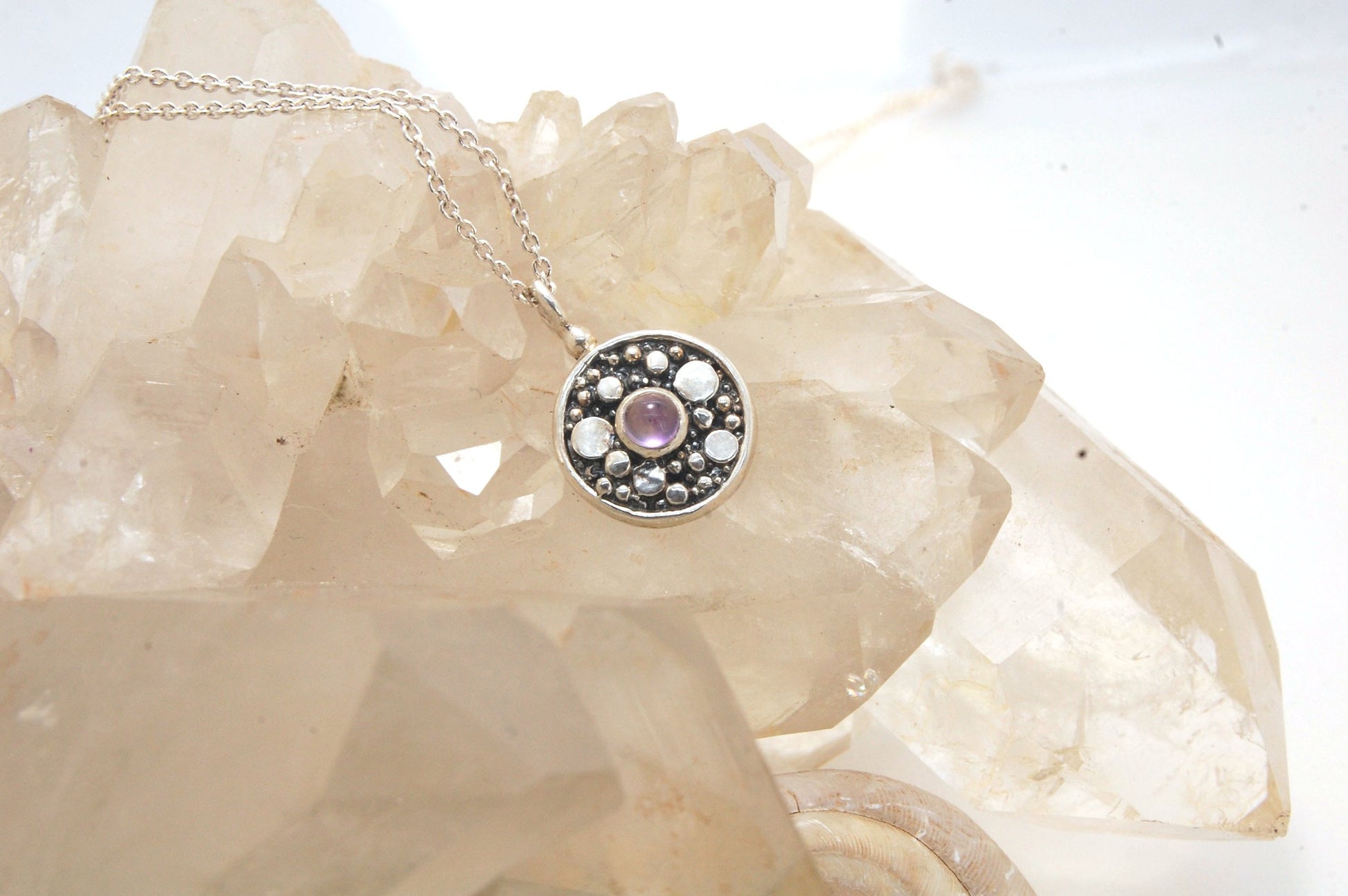 Cluster Charm in Sterling Silver with Moonstone, Iolite, Amethyst, or Garnet This sweet Cluster Charm is a Sterling Silver cast from a Fine Silver granulated original. You can choose from several stones for the center: Moonstone, Iolite , Amethyst, or Gar