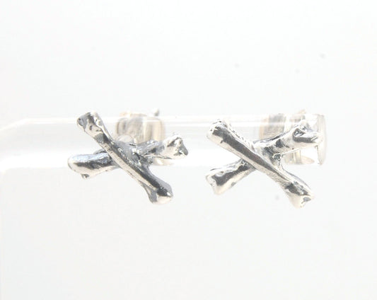 Crossbones Studs These solid sterling silver Crossbones Studs are wax carved by hand and cast using the ancient process of Lost Wax to cast them in sterling silver. I then made a mold, which I can inject with wax and make wax copies of the Crossbones and