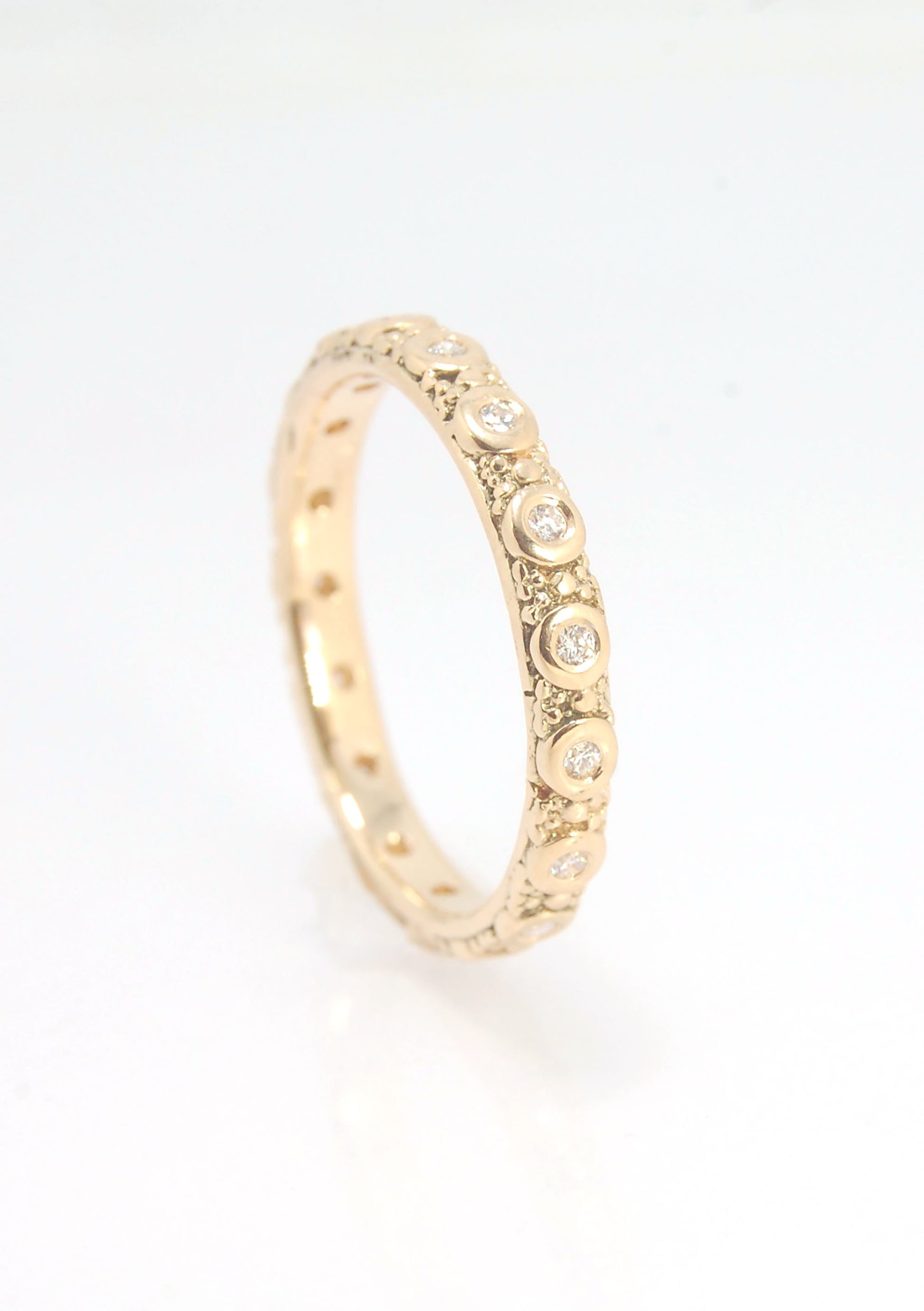 Diamond Eternity Band - Order in 14k, 18k or Sterling Silver The subtle sparkle of this band is a delight! This is a 3mm patterned band with ethically sourced, 1.5 mm SI2-SI3 F+ Round Diamonds bezel set in each disc around the band. This is a cast version