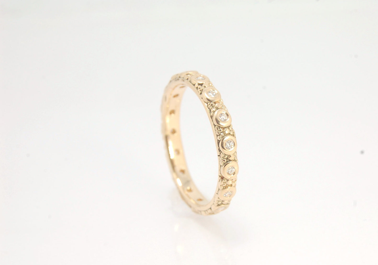 Diamond Eternity Band - Order in 14k, 18k or Sterling Silver The subtle sparkle of this band is a delight! This is a 3mm patterned band with ethically sourced, 1.5 mm SI2-SI3 F+ Round Diamonds bezel set in each disc around the band. This is a cast version