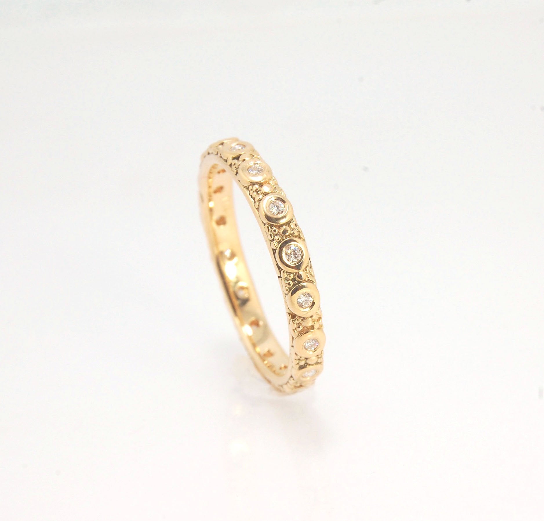 Diamond Eternity Band - Order in 14k, 18k or Sterling Silver The subtle sparkle of this band is a delight! This is a 3mm patterned band with ethically sourced, 1.5 mm SI2-SI3 F+ Round Diamonds bezel set in each disc around the band. This is a cast version