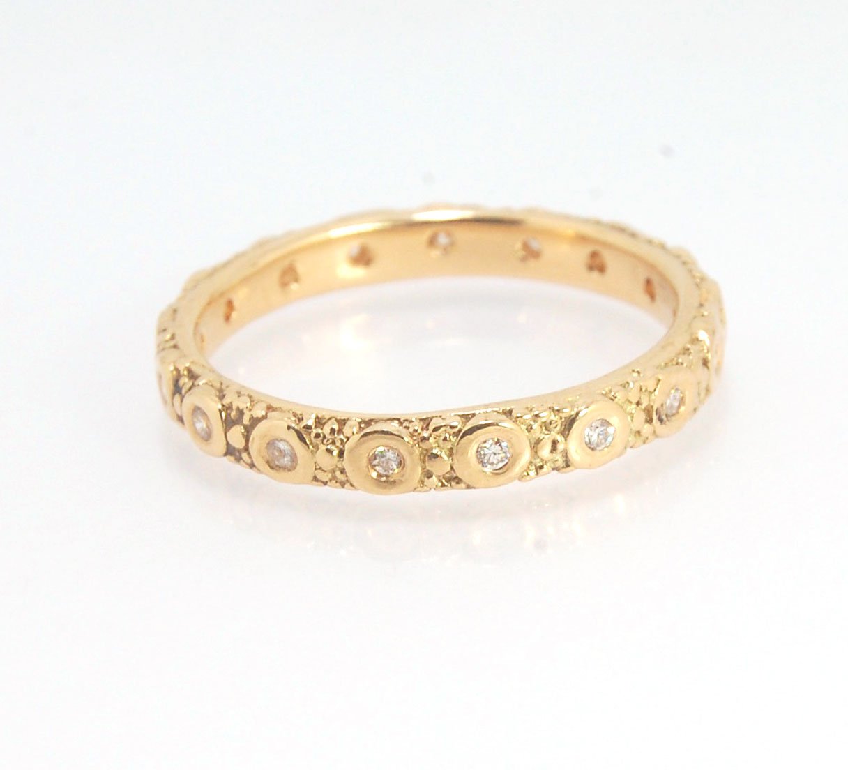 Diamond Eternity Band - Order in 14k, 18k or Sterling Silver The subtle sparkle of this band is a delight! This is a 3mm patterned band with ethically sourced, 1.5 mm SI2-SI3 F+ Round Diamonds bezel set in each disc around the band. This is a cast version