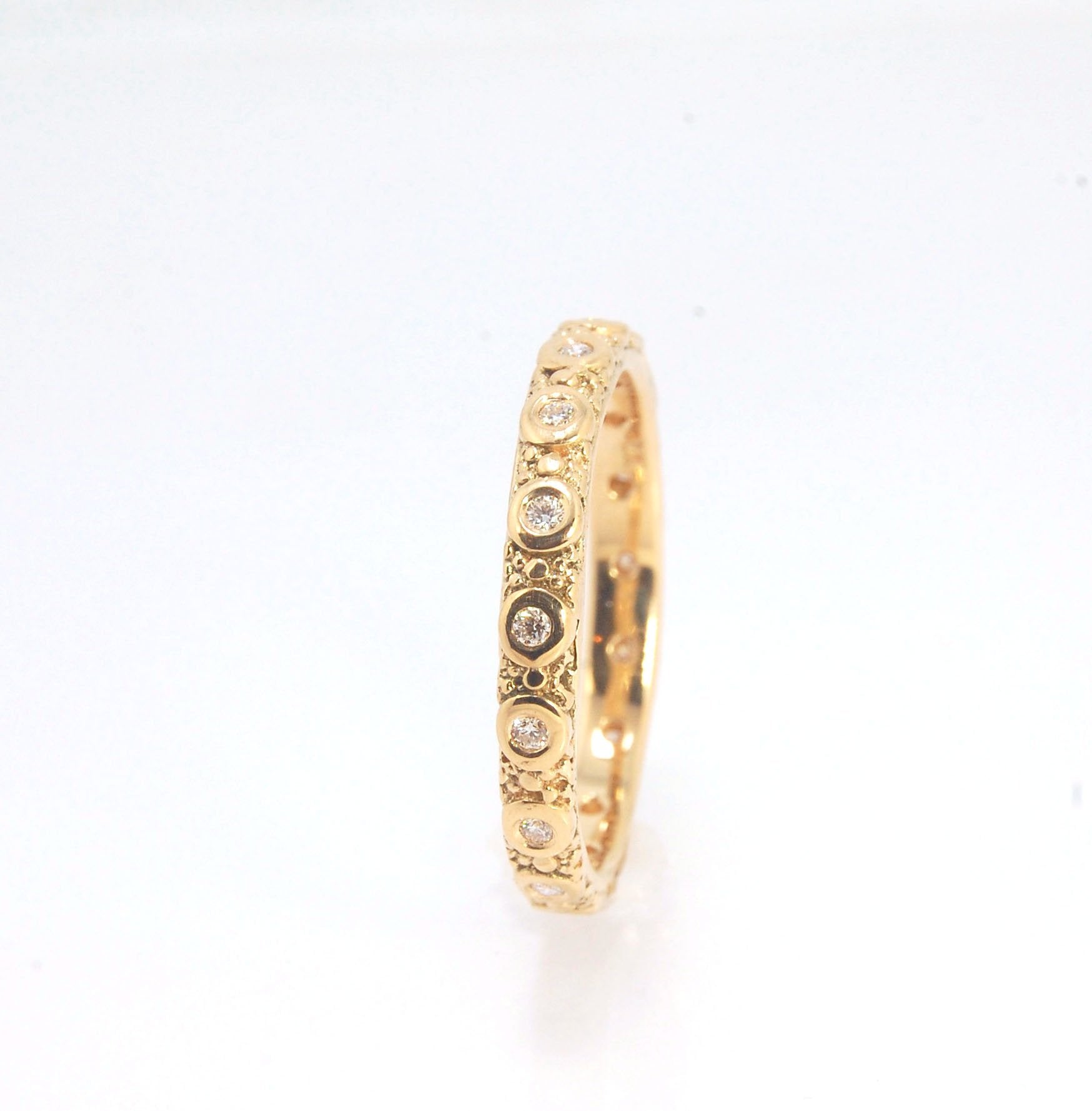 Diamond Eternity Band - Order in 14k, 18k or Sterling Silver The subtle sparkle of this band is a delight! This is a 3mm patterned band with ethically sourced, 1.5 mm SI2-SI3 F+ Round Diamonds bezel set in each disc around the band. This is a cast version