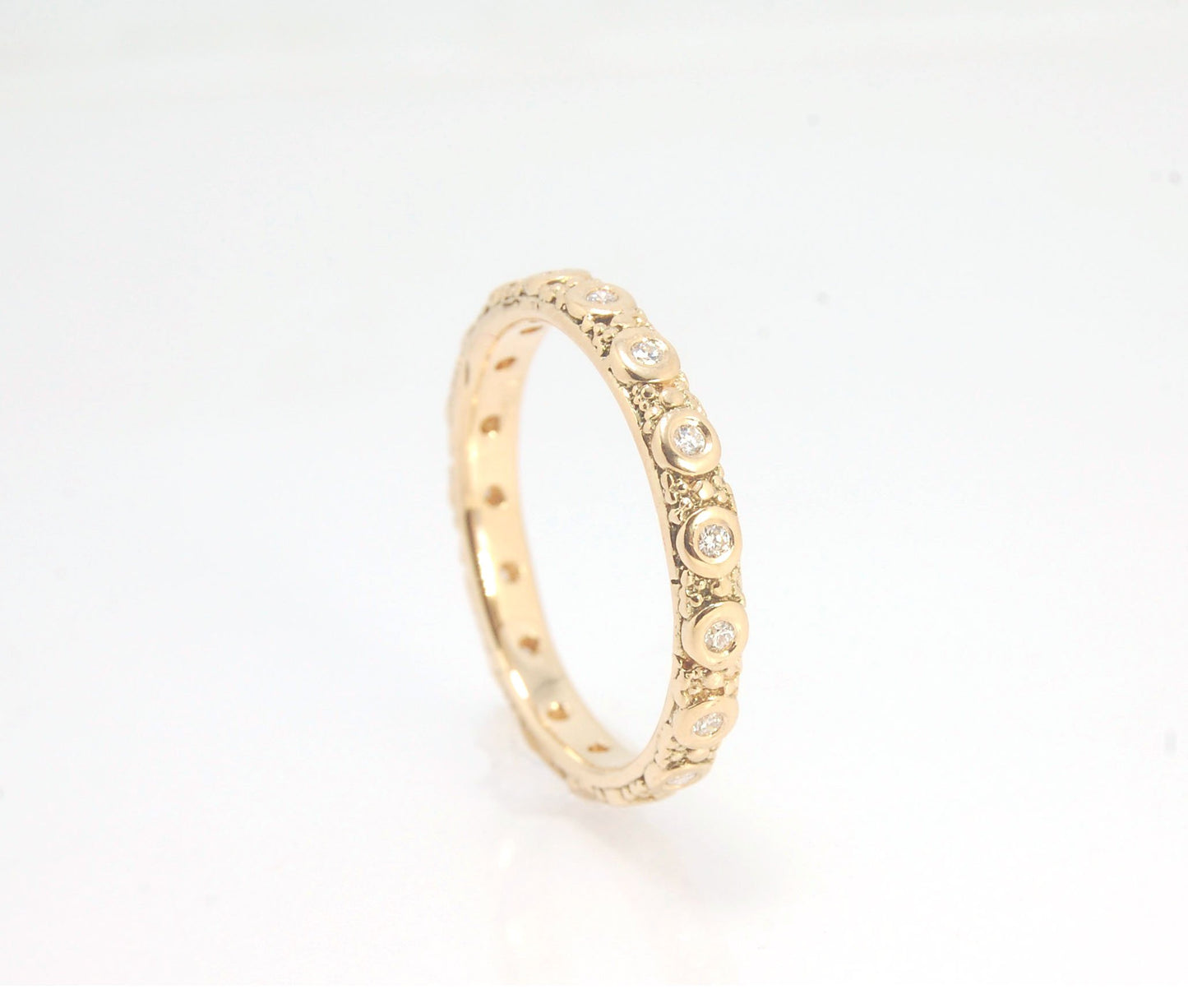 Diamond Eternity Band - Order in 14k, 18k or Sterling Silver The subtle sparkle of this band is a delight! This is a 3mm patterned band with ethically sourced, 1.5 mm SI2-SI3 F+ Round Diamonds bezel set in each disc around the band. This is a cast version