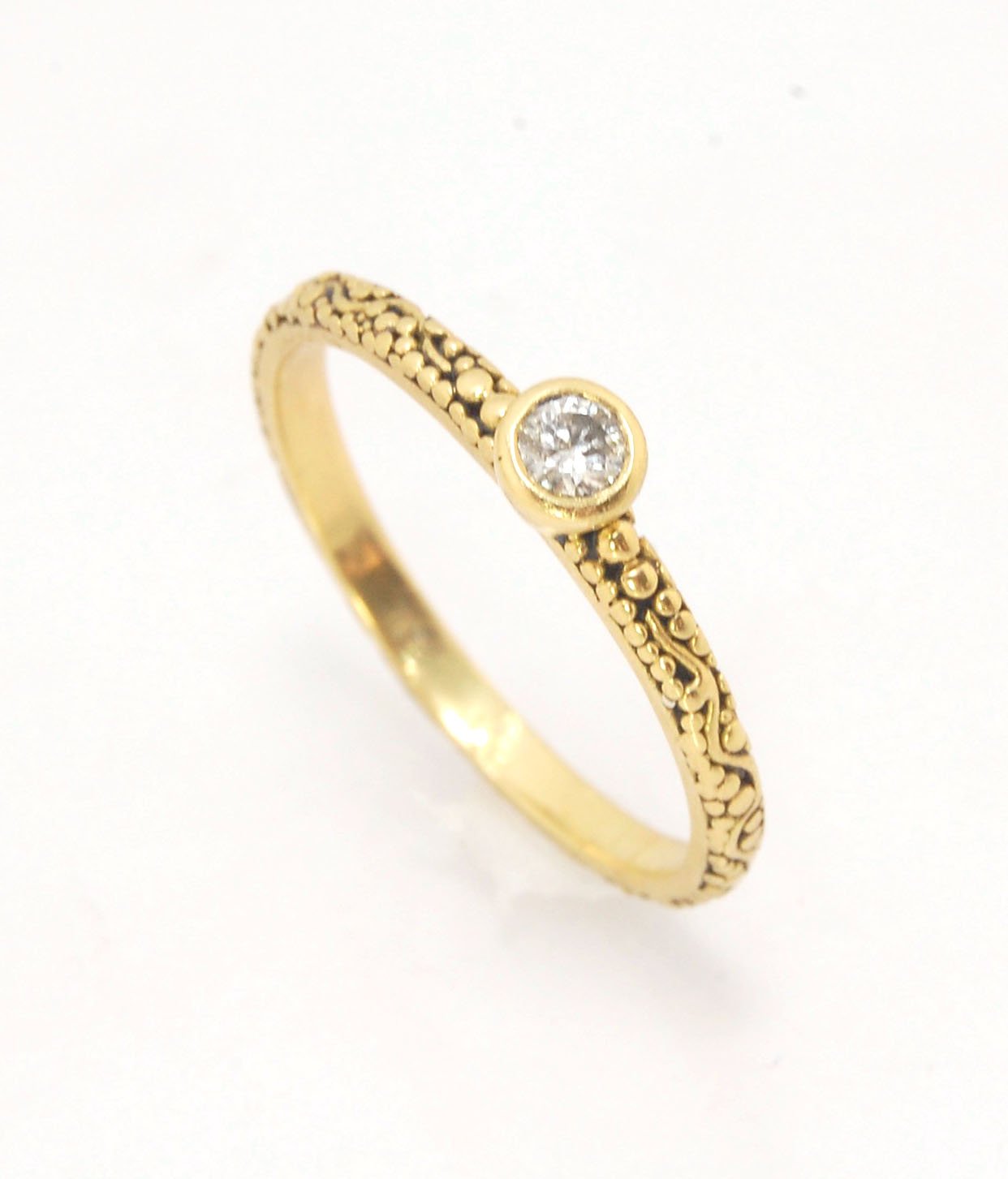 Twining Band Diamond Solitaire Ring in 18k Granulation This is a one-of-a-kind solitaire 18k ring. The twining band is 2mm wide and has a continuous pattern around made with an ancient and unique process of granulation in 18k gold alloyed in my studio. Th