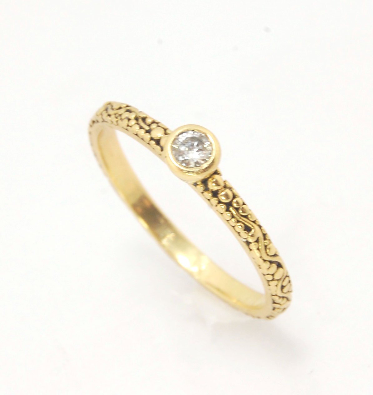 Twining Band Diamond Solitaire Ring in 18k Granulation This is a one-of-a-kind solitaire 18k ring. The twining band is 2mm wide and has a continuous pattern around made with an ancient and unique process of granulation in 18k gold alloyed in my studio. Th