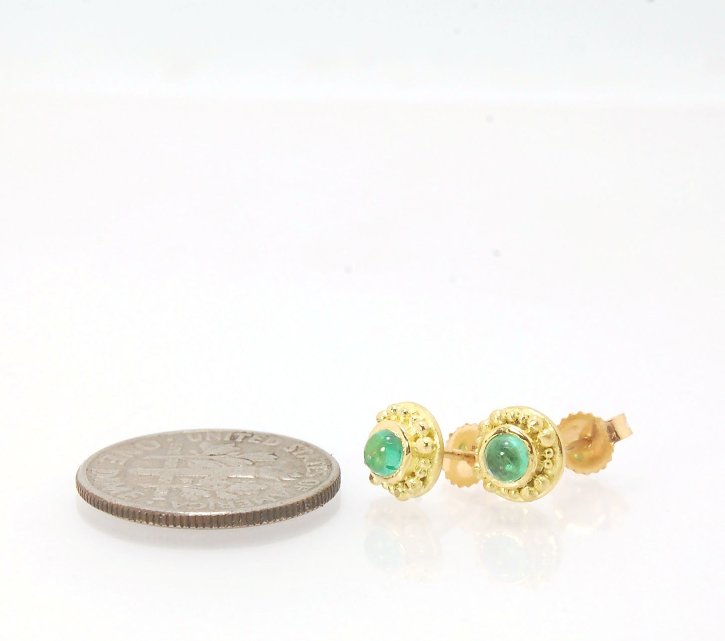 Emerald Cabochon 18k post earrings These stunning emerald cabochons are bezel-set in 18k gold with 18k granulation around the outside. These are 18k gold post earrings with a 14k gold ear nut. Classic and understated. But that color, though! Ya’ll know I