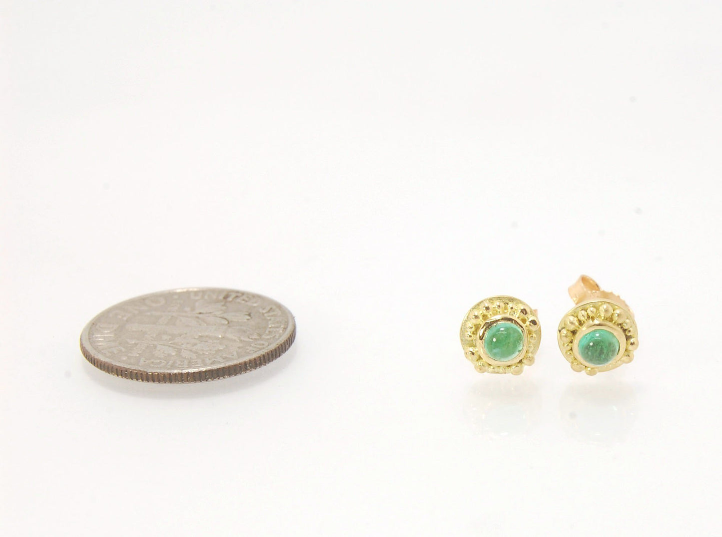 Emerald Cabochon 18k post earrings These stunning emerald cabochons are bezel-set in 18k gold with 18k granulation around the outside. These are 18k gold post earrings with a 14k gold ear nut. Classic and understated. But that color, though! Ya’ll know I