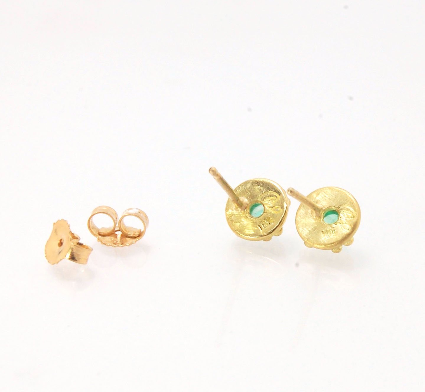 Emerald Cabochon 18k post earrings These stunning emerald cabochons are bezel-set in 18k gold with 18k granulation around the outside. These are 18k gold post earrings with a 14k gold ear nut. Classic and understated. But that color, though! Ya’ll know I