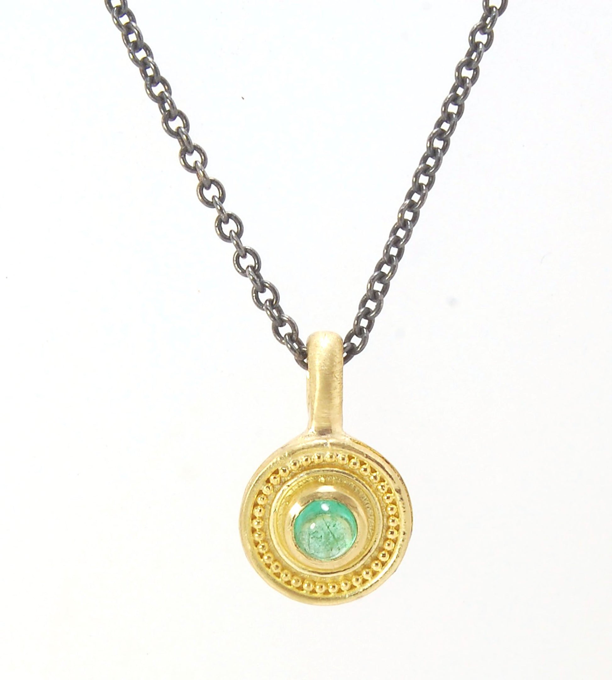 Emerald Cabochon 22k gold Tiny Granulated Disk Pendant The sweetest tiny emerald pendant yet!This lovely, luminous, ethically sourced emerald is bezel-set in 18k rich yellow gold granulation on 18k gold. Granulation is an ancient fusing process utilized f