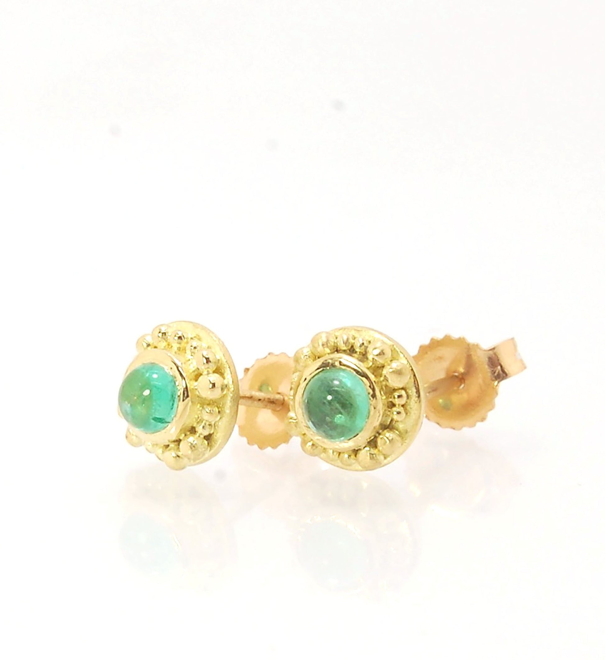 Emerald Cabochon 18k post earrings These stunning emerald cabochons are bezel-set in 18k gold with 18k granulation around the outside. These are 18k gold post earrings with a 14k gold ear nut. Classic and understated. But that color, though! Ya’ll know I