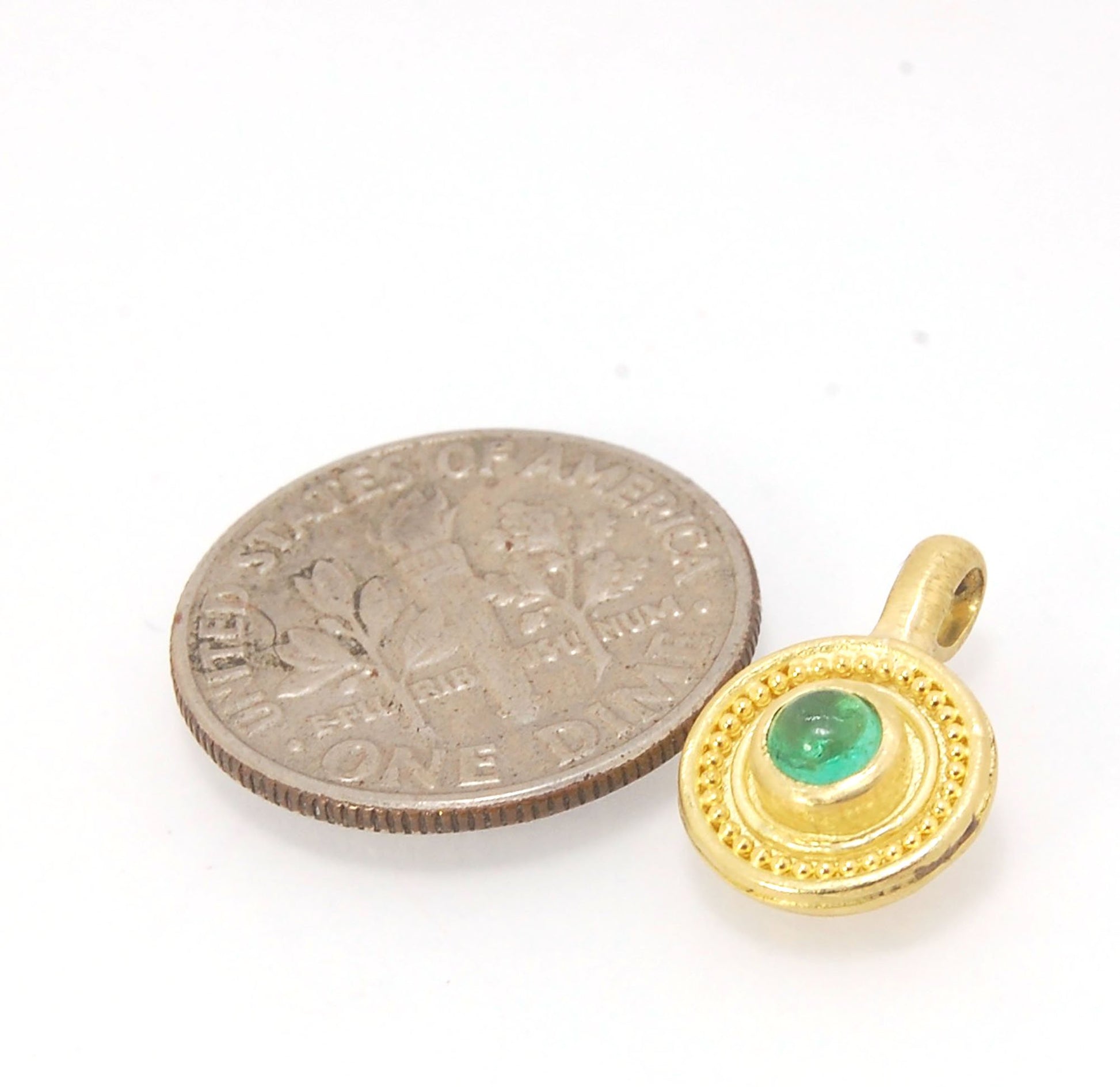 Emerald Cabochon 22k gold Tiny Granulated Disk Pendant The sweetest tiny emerald pendant yet!This lovely, luminous, ethically sourced emerald is bezel-set in 18k rich yellow gold granulation on 18k gold. Granulation is an ancient fusing process utilized f