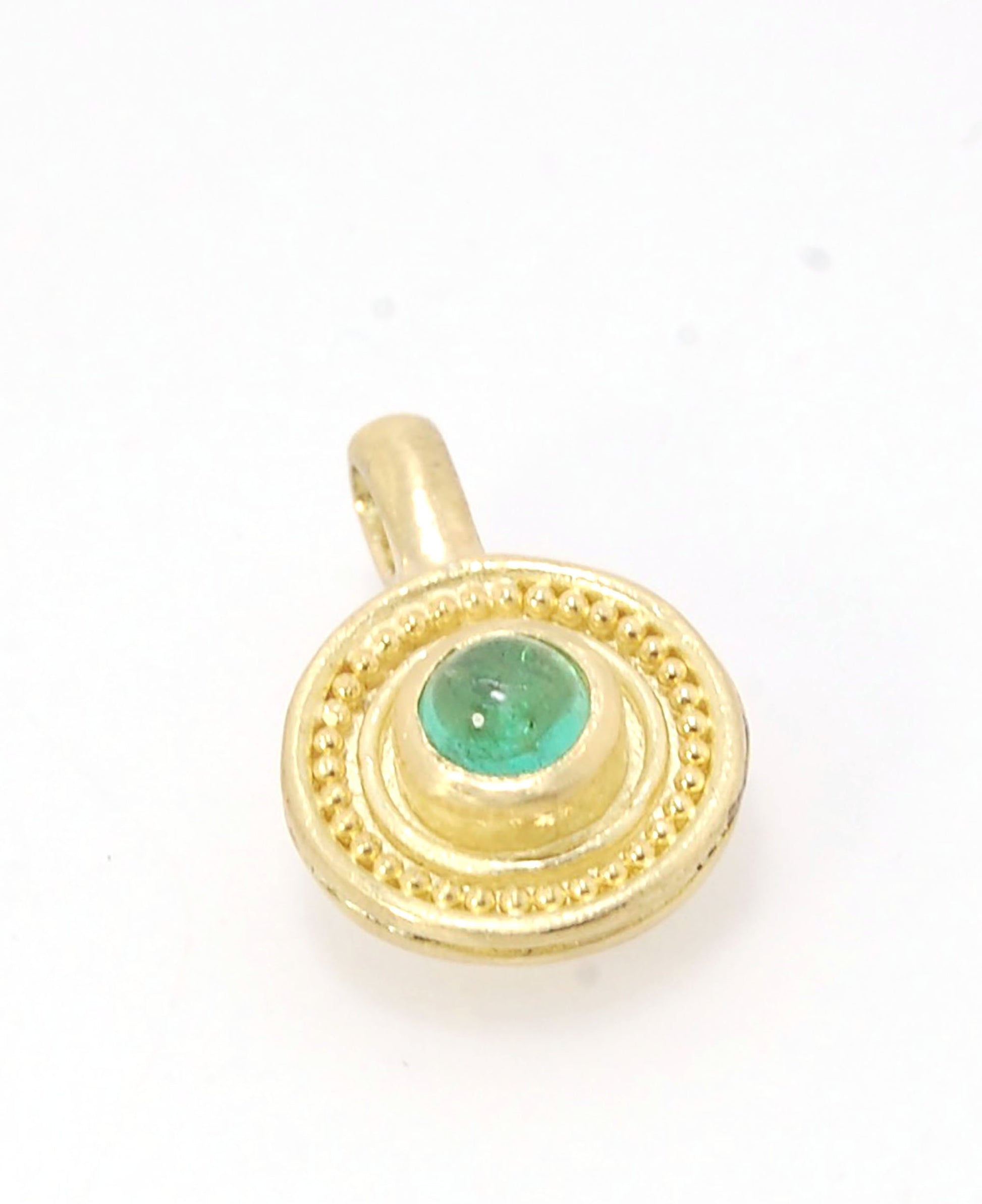 Emerald Cabochon 22k gold Tiny Granulated Disk Pendant The sweetest tiny emerald pendant yet!This lovely, luminous, ethically sourced emerald is bezel-set in 18k rich yellow gold granulation on 18k gold. Granulation is an ancient fusing process utilized f