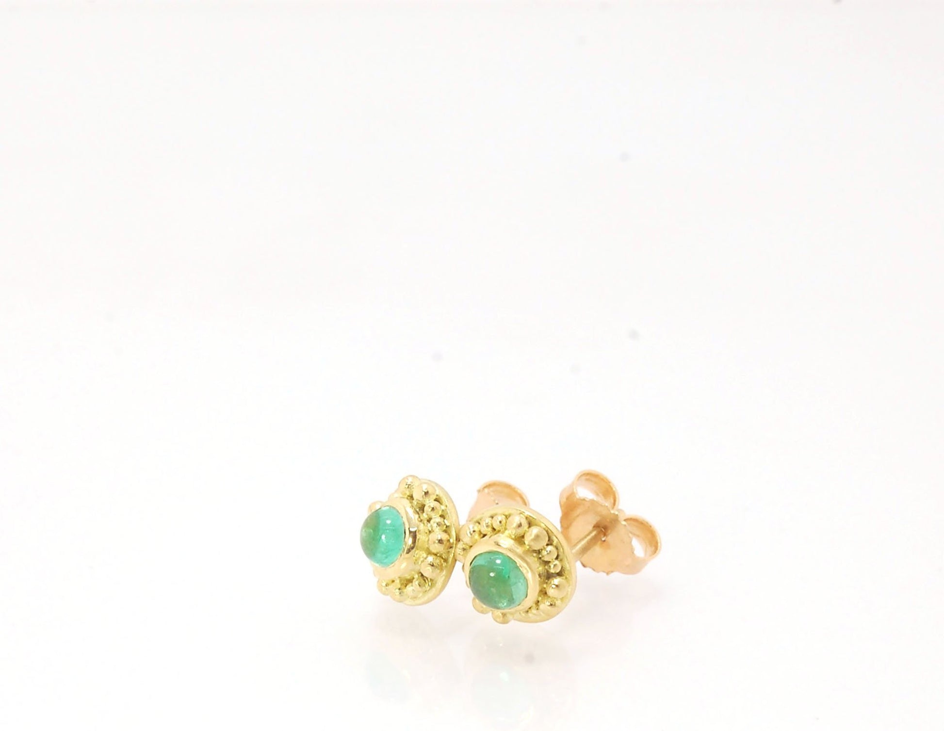 Emerald Cabochon 18k post earrings These stunning emerald cabochons are bezel-set in 18k gold with 18k granulation around the outside. These are 18k gold post earrings with a 14k gold ear nut. Classic and understated. But that color, though! Ya’ll know I