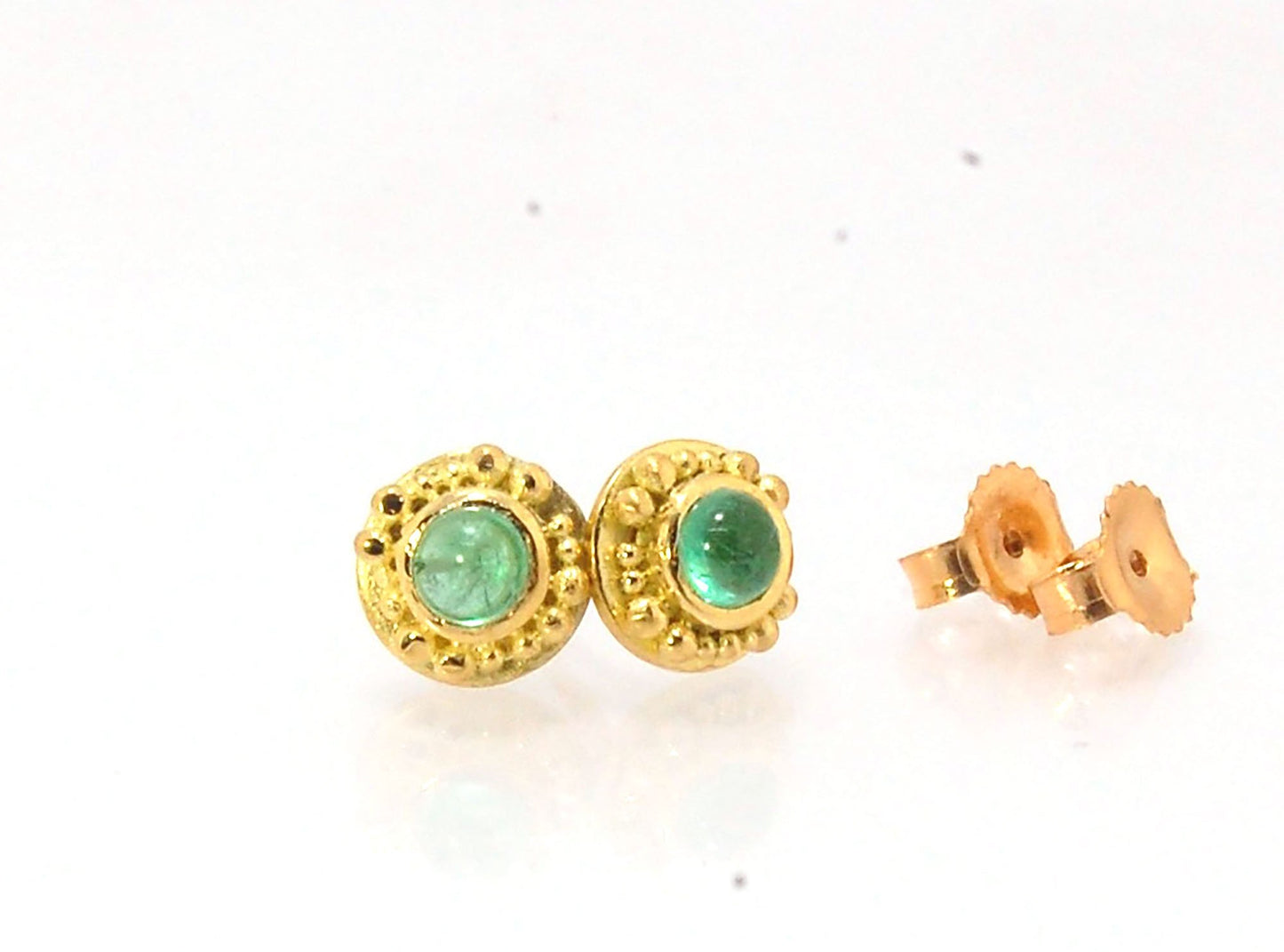 Emerald Cabochon 18k post earrings These stunning emerald cabochons are bezel-set in 18k gold with 18k granulation around the outside. These are 18k gold post earrings with a 14k gold ear nut. Classic and understated. But that color, though! Ya’ll know I