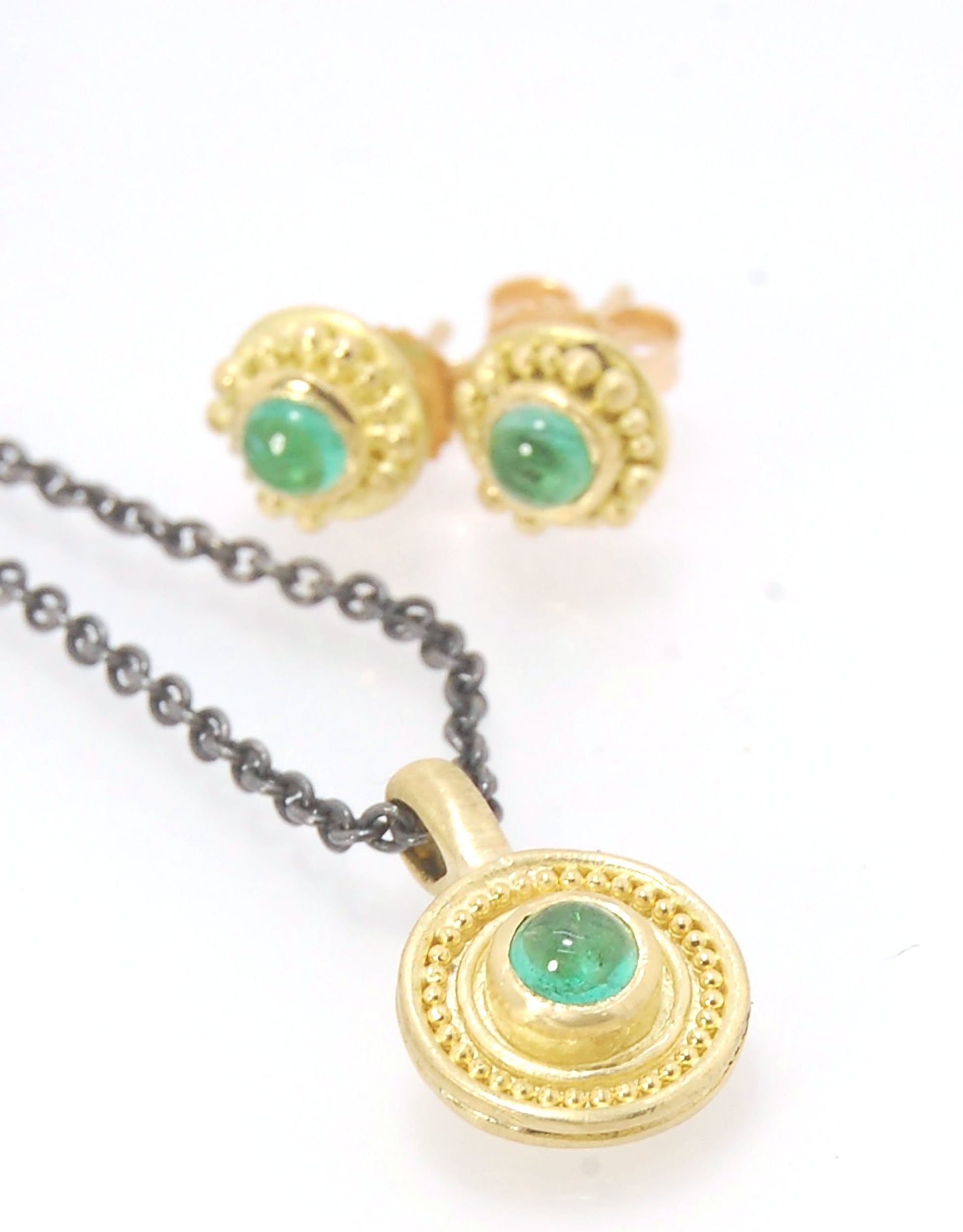 Emerald Cabochon 22k gold Tiny Granulated Disk Pendant The sweetest tiny emerald pendant yet!This lovely, luminous, ethically sourced emerald is bezel-set in 18k rich yellow gold granulation on 18k gold. Granulation is an ancient fusing process utilized f