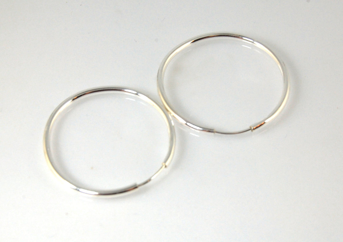 Sterling Eternity Hoops 1" These eternity hoop earrings are secure, lightweight and comfortable to wear everyday.These hoops are 30mm (approx. 1”)Sterling SilverMADE TO ORDER - Ships in 3-10 days