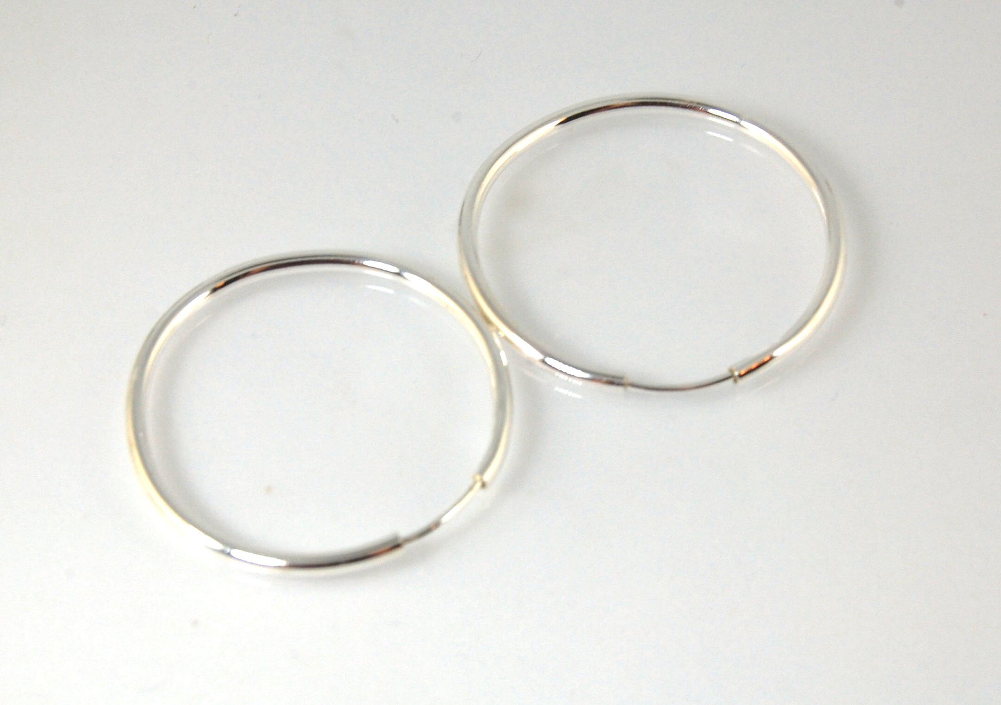 Sterling Eternity Hoops 1" These eternity hoop earrings are secure, lightweight and comfortable to wear everyday.These hoops are 30mm (approx. 1”)Sterling SilverMADE TO ORDER - Ships in 3-10 days