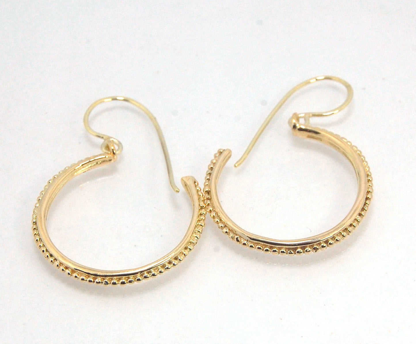 Etruscan hoop Dangles with French Hooks in 14k Gold - Large These 14k yellow gold hoops are cast in my studio from an original granulated master for a limited edition series of hoops. I use fine silver for the original granulation, then make a mold, pull