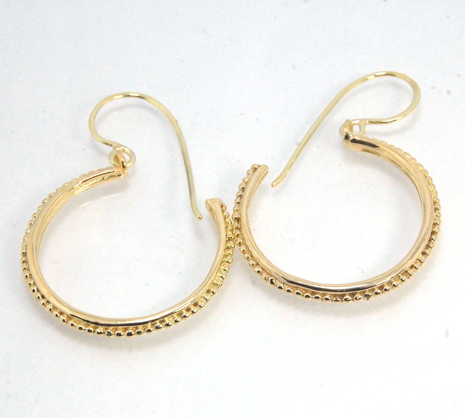 Etruscan hoop Dangles with French Hooks in 14k Gold - Large These 14k yellow gold hoops are cast in my studio from an original granulated master for a limited edition series of hoops. I use fine silver for the original granulation, then make a mold, pull