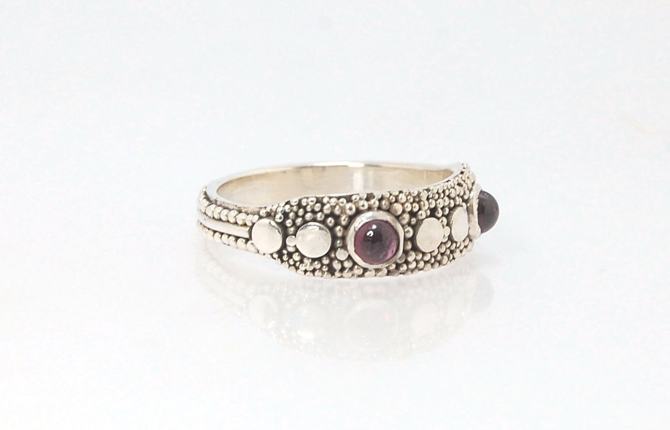 Rhodolite Garnet Shield Ring with Granulation in Fine Silver Rhodolite Garnet Cabochons bezel-set in fine silver granulation with large circles and a granulated shank. Granulation is a controlled fusing process that has been utilized for thousands of year