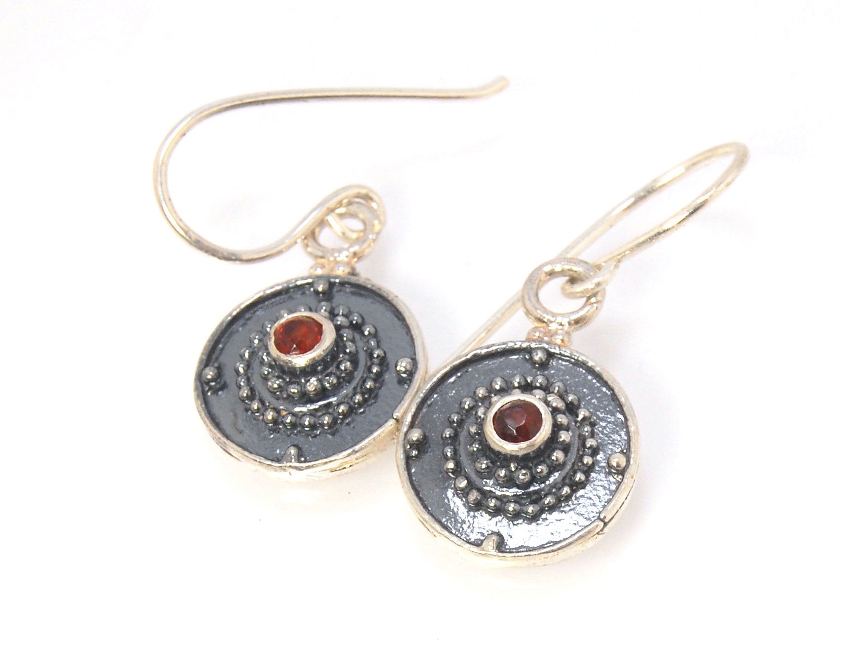 Dangle Shield Earrings in Sterling with Pink Garnet, Red Garnet, Blue Topaz, Peridot, or Amethyst These terrific shield earrings are cast from a granulated original. and is cast using the lost wax process. You can choose which stone to set in your sterlin