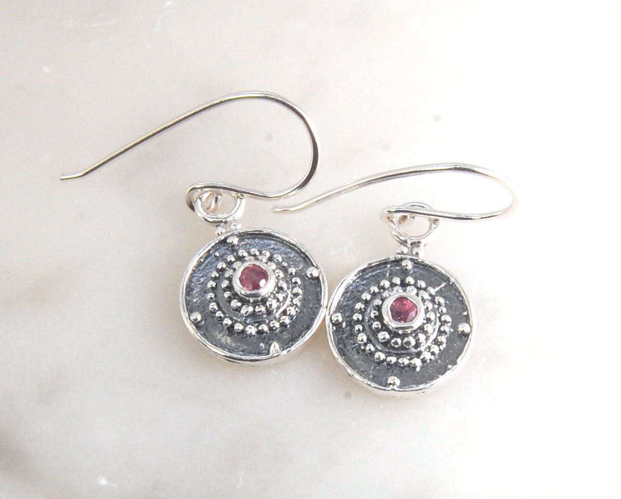 Dangle Shield Earrings in Sterling with Pink Garnet, Red Garnet, Blue Topaz, Peridot, or Amethyst These terrific shield earrings are cast from a granulated original. and is cast using the lost wax process. You can choose which stone to set in your sterlin