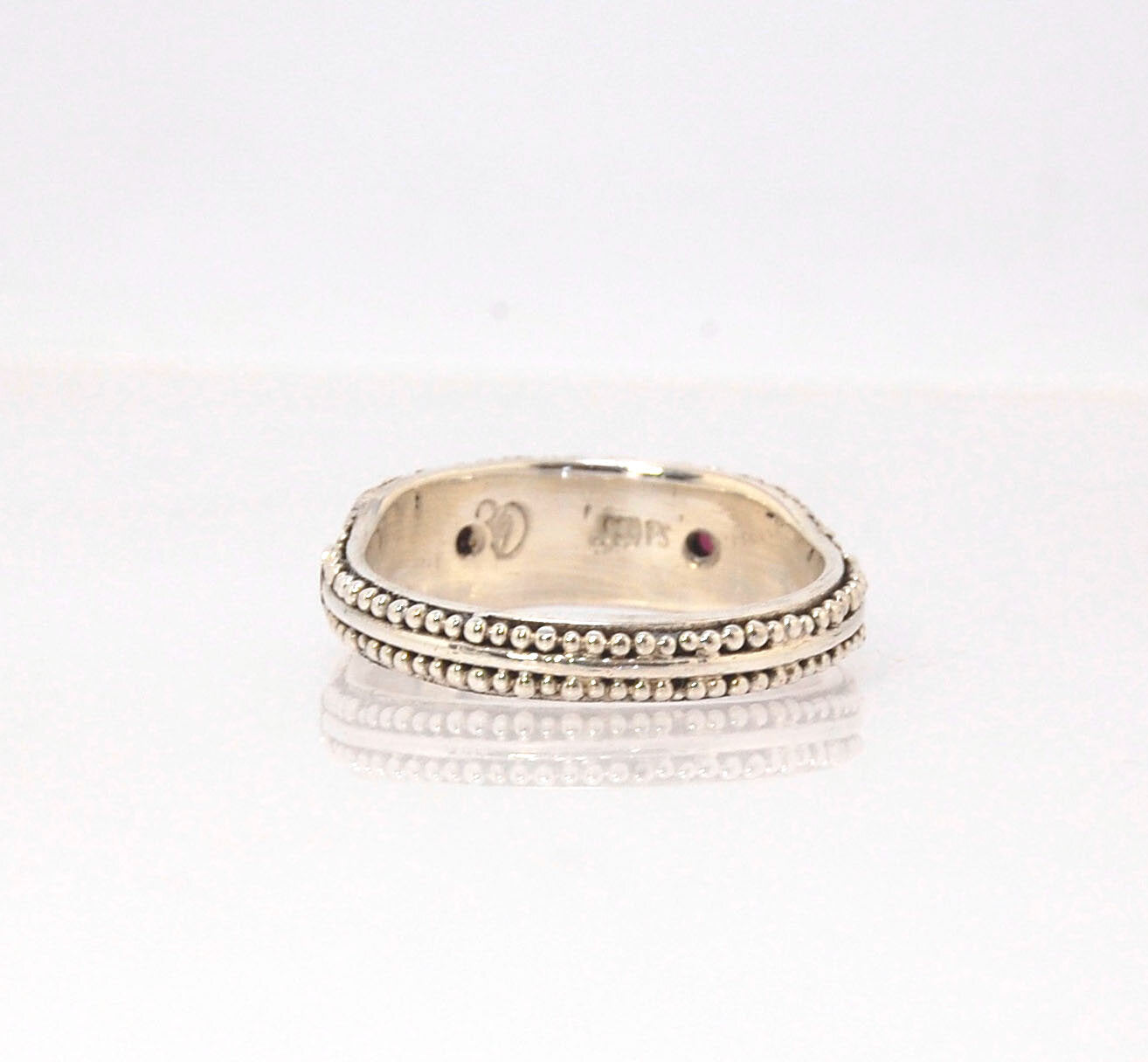 Rhodolite Garnet Shield Ring with Granulation in Fine Silver Rhodolite Garnet Cabochons bezel-set in fine silver granulation with large circles and a granulated shank. Granulation is a controlled fusing process that has been utilized for thousands of year