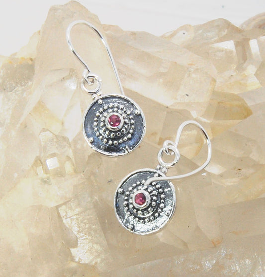 Dangle Shield Earrings in Sterling with Pink Garnet, Red Garnet, Blue Topaz, Peridot, or Amethyst These terrific shield earrings are cast from a granulated original. and is cast using the lost wax process. You can choose which stone to set in your sterlin