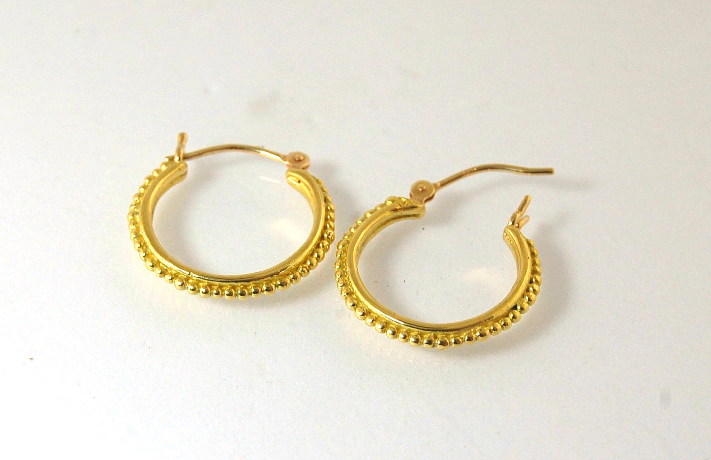 Light Etruscan Hoops in 14k gold - 15mm - lightweight These 14k yellow gold hoops are cast in my studio (actually on the deck as casting needs good ventilation) from a granulated master for a limited edition series of hoops. I use fine silver for the orig