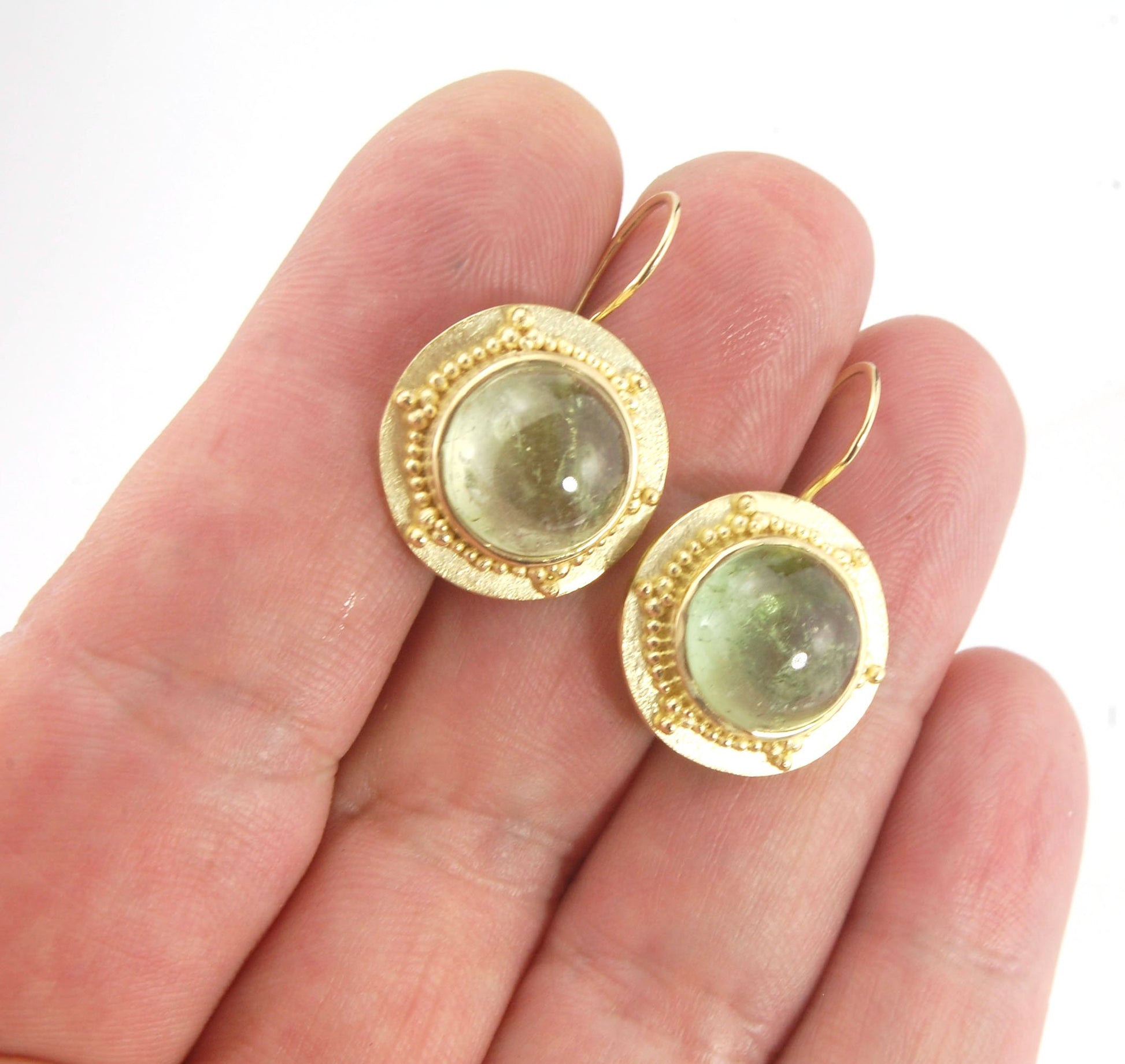 Green Bi-color Tourmaline 18k Gold Granulation Earrings These Green Bi-color Tourmaline 18k Gold Granulation Earrings are Classically-inspired 18k granulation. With 2 luminous and clear bi-color tourmaline cabochons bezel-set in 18k an accented ring of 18