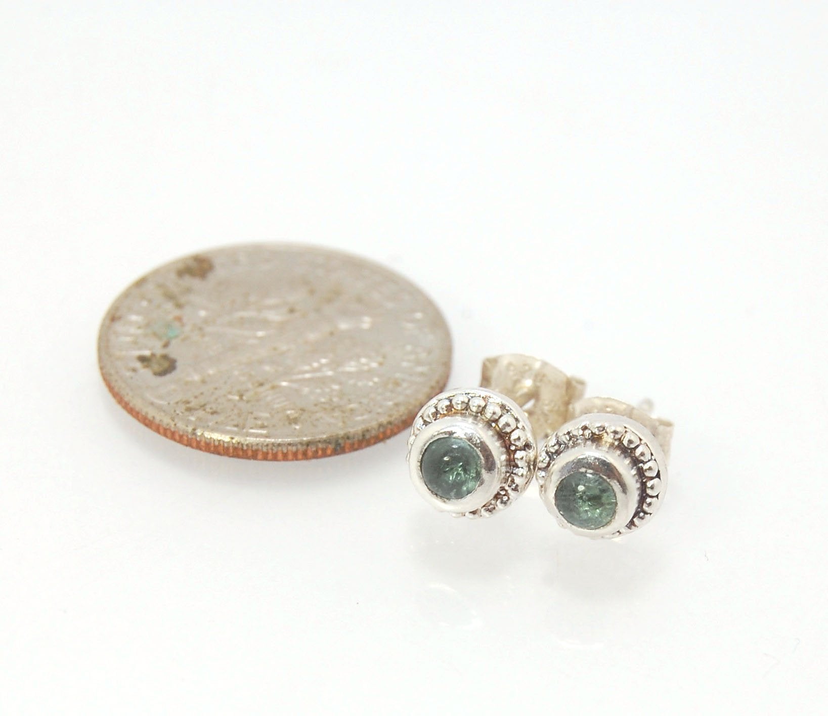 BlueGreen Tourmaline Tiny Post Earrings in Sterling Silver These are tiny bezel settings I created using the ancient process of granulation. Then I made a mold of it and injected the mold with wax and used that wax to create a Sterling Silver version of t