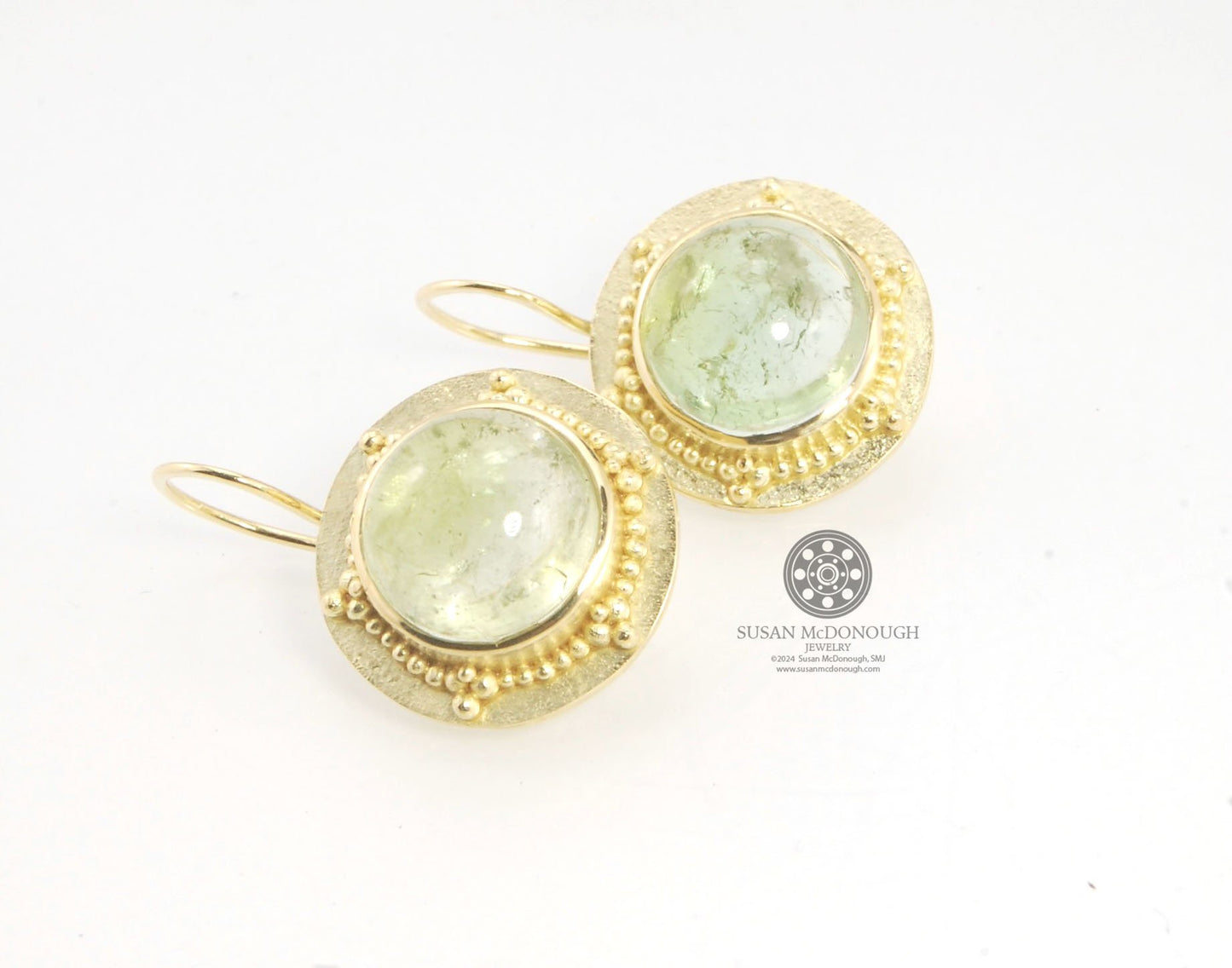 Green Bi-color Tourmaline 18k Gold Granulation Earrings These Green Bi-color Tourmaline 18k Gold Granulation Earrings are Classically-inspired 18k granulation. With 2 luminous and clear bi-color tourmaline cabochons bezel-set in 18k an accented ring of 18