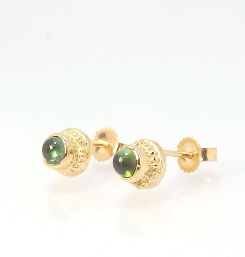 Green Tourmaline Classic Cast Granulation Studs in 14k These are tiny bezel settings I created using the ancient process of granulation. Then I made a mold of it and injected the mold with wax and used that wax to create a 14k gold version of these granul