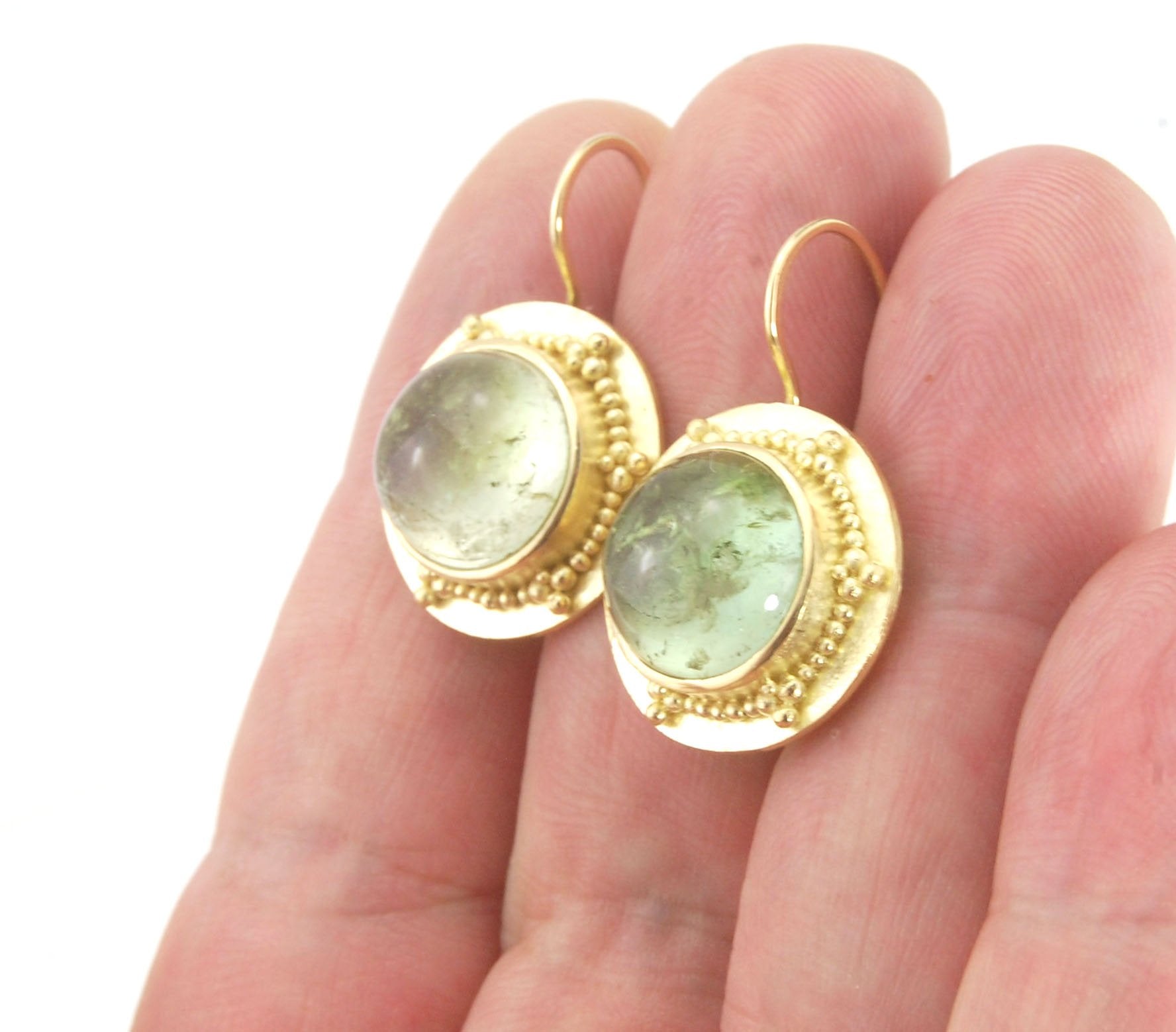 Green Bi-color Tourmaline 18k Gold Granulation Earrings These Green Bi-color Tourmaline 18k Gold Granulation Earrings are Classically-inspired 18k granulation. With 2 luminous and clear bi-color tourmaline cabochons bezel-set in 18k an accented ring of 18