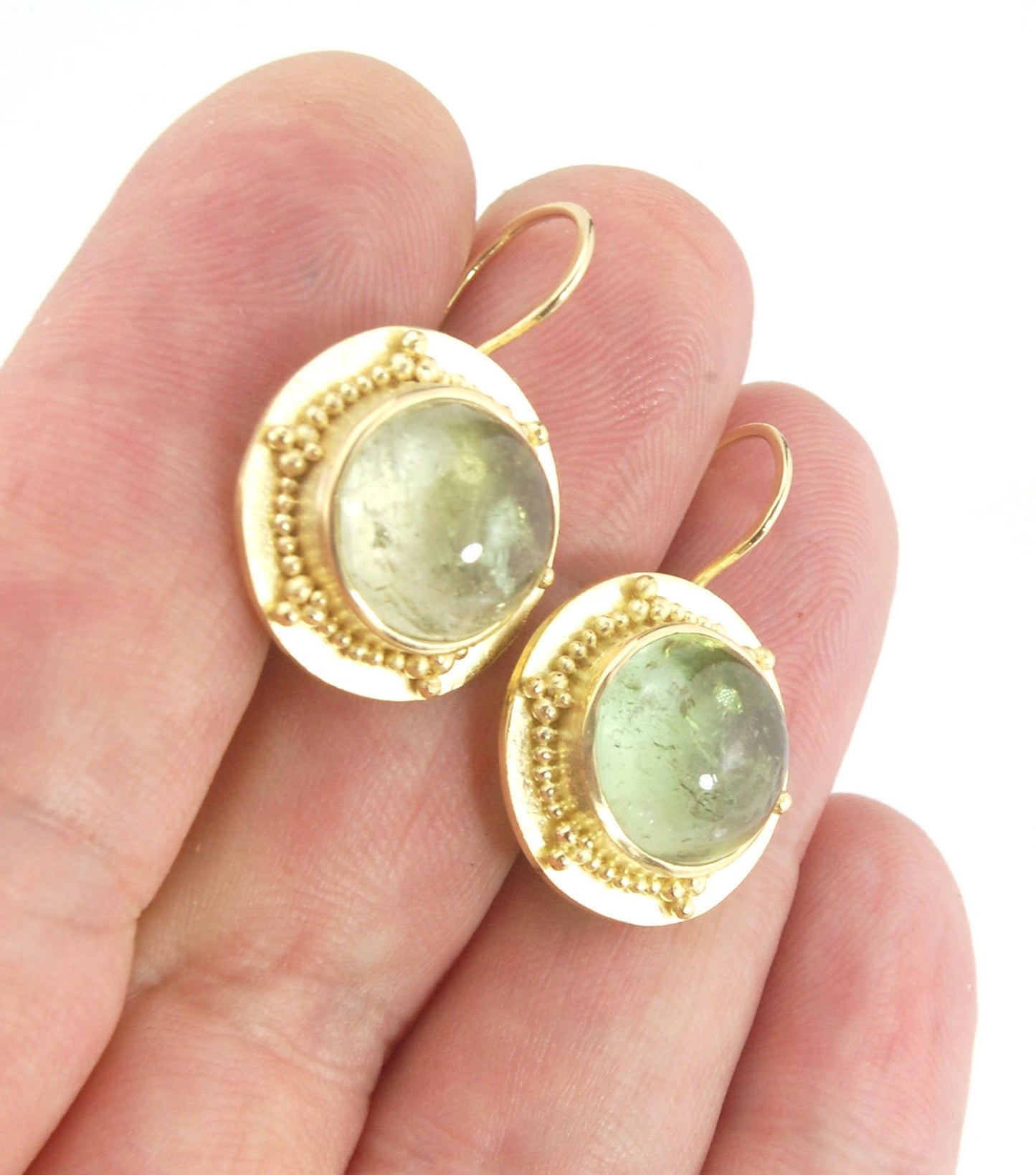 Green Bi-color Tourmaline 18k Gold Granulation Earrings These Green Bi-color Tourmaline 18k Gold Granulation Earrings are Classically-inspired 18k granulation. With 2 luminous and clear bi-color tourmaline cabochons bezel-set in 18k an accented ring of 18