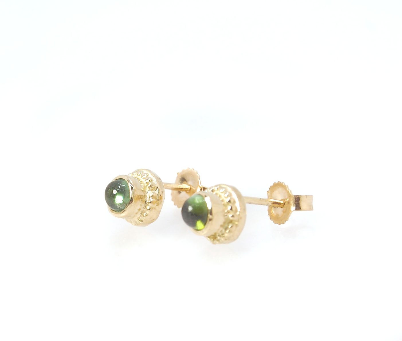 Green Tourmaline Classic Cast Granulation Studs in 14k These are tiny bezel settings I created using the ancient process of granulation. Then I made a mold of it and injected the mold with wax and used that wax to create a 14k gold version of these granul