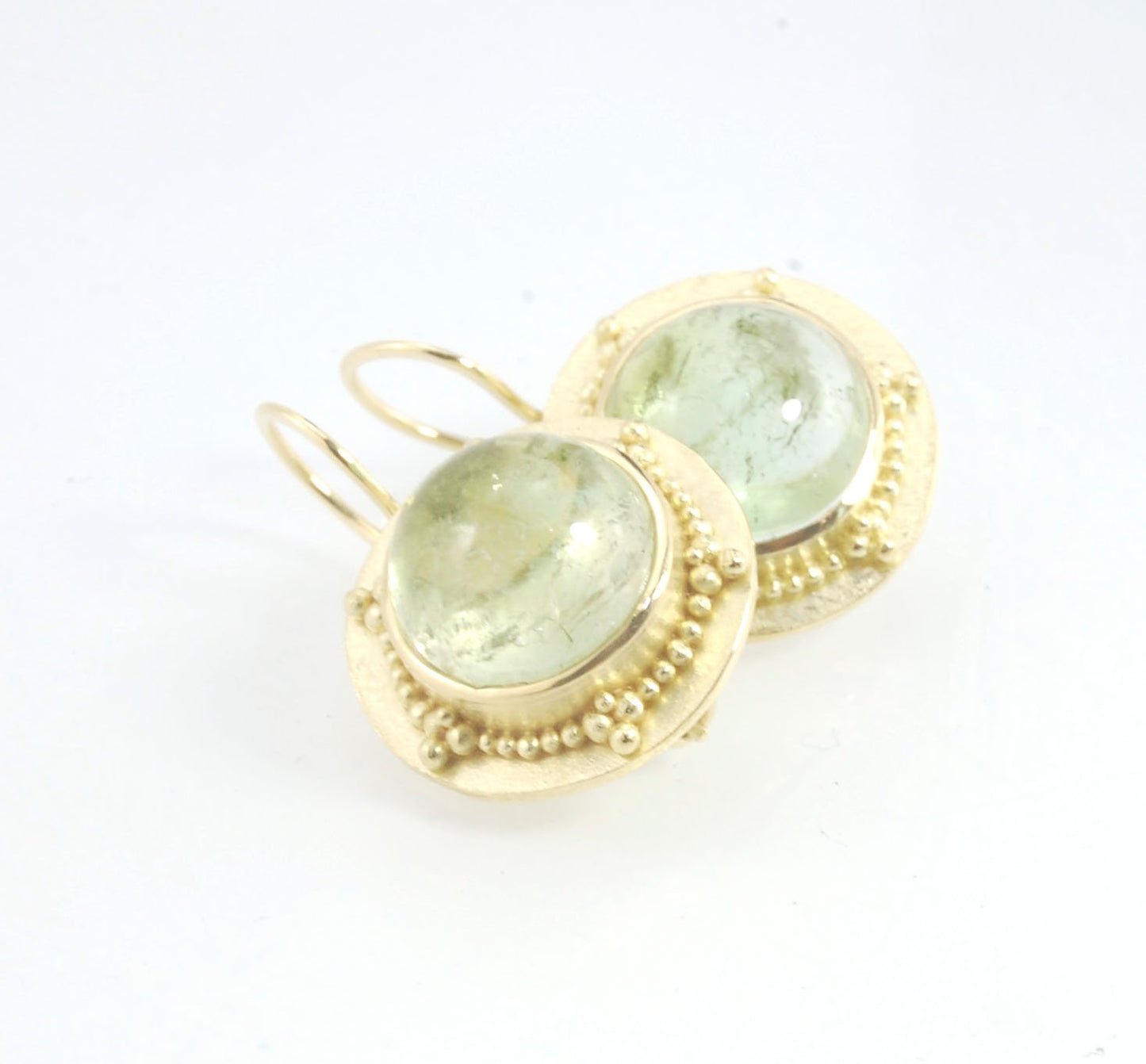 Green Bi-color Tourmaline 18k Gold Granulation Earrings These Green Bi-color Tourmaline 18k Gold Granulation Earrings are Classically-inspired 18k granulation. With 2 luminous and clear bi-color tourmaline cabochons bezel-set in 18k an accented ring of 18