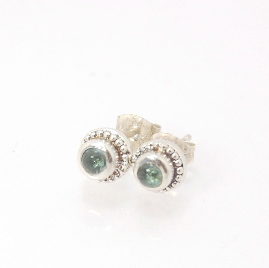 BlueGreen Tourmaline Tiny Post Earrings in Sterling Silver These are tiny bezel settings I created using the ancient process of granulation. Then I made a mold of it and injected the mold with wax and used that wax to create a Sterling Silver version of t