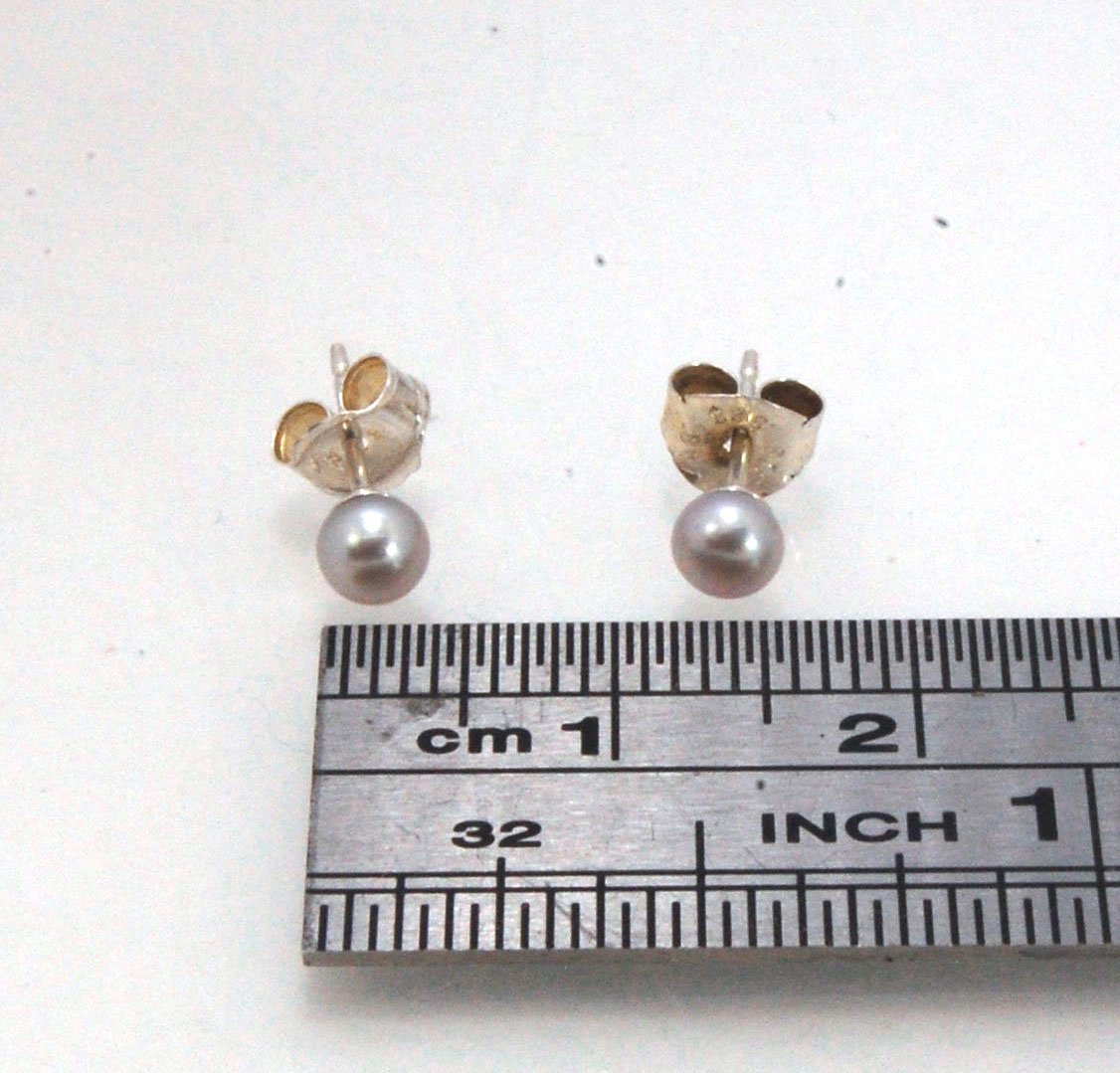 Grey Freshwater pearls studs in Sterling silver - 4mm These tiny luminous grey freshwater pearls are 4mm and set in sterling silver pearl cups and posts with sterling silver ear nuts. Made to Order Sterling and Freshwater pearls